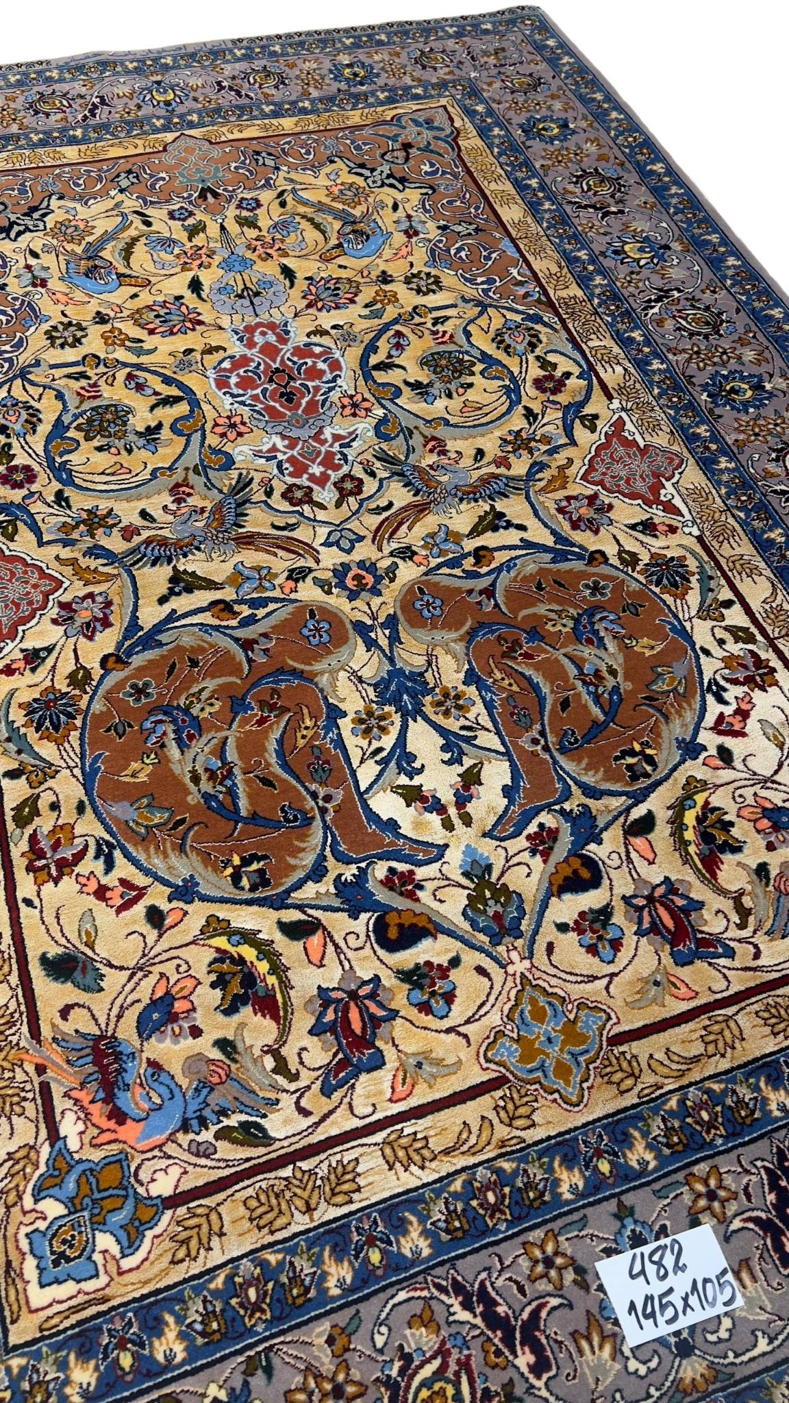 Hand-knotted Persian Isfahan rug with bird and floral motifs.
