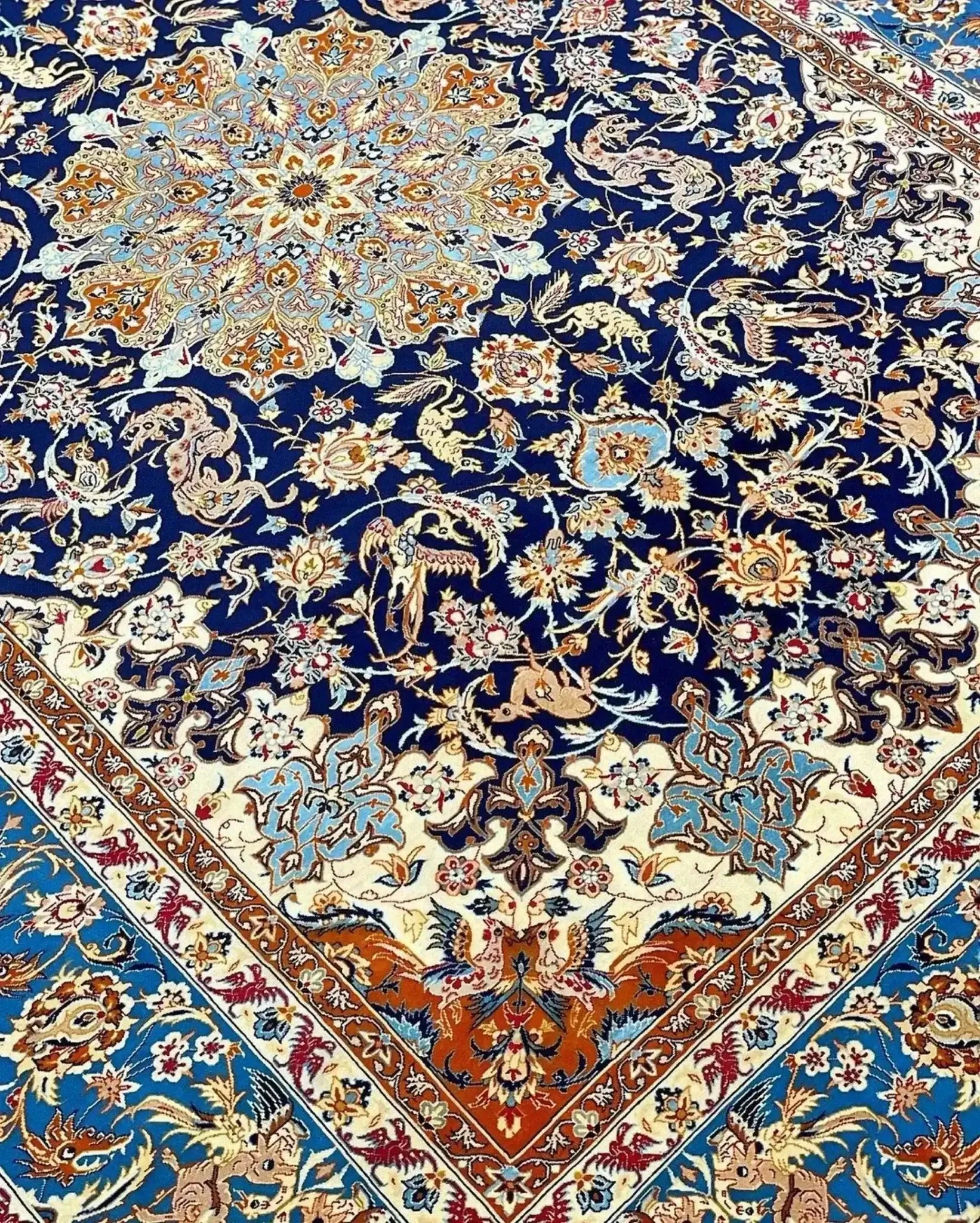 "Vintage Isfahan Persian rug with golden medallion on black background, hand-knotted in Iran."