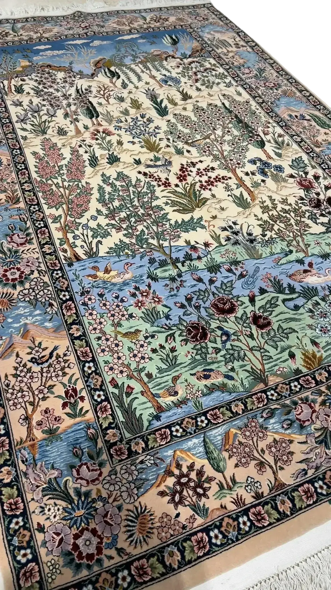 "Premium handmade Persian rug with trees, ducks, rivers, and nature patterns on a soft cream background."