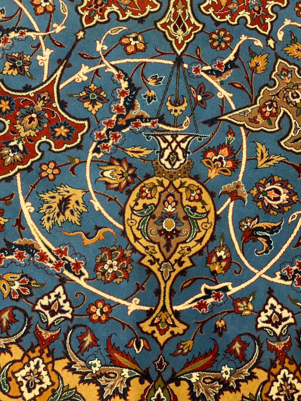 "Backside view of red and blue Persian rug, showing hand-knotted craftsmanship by Ahmad Shabpour."
