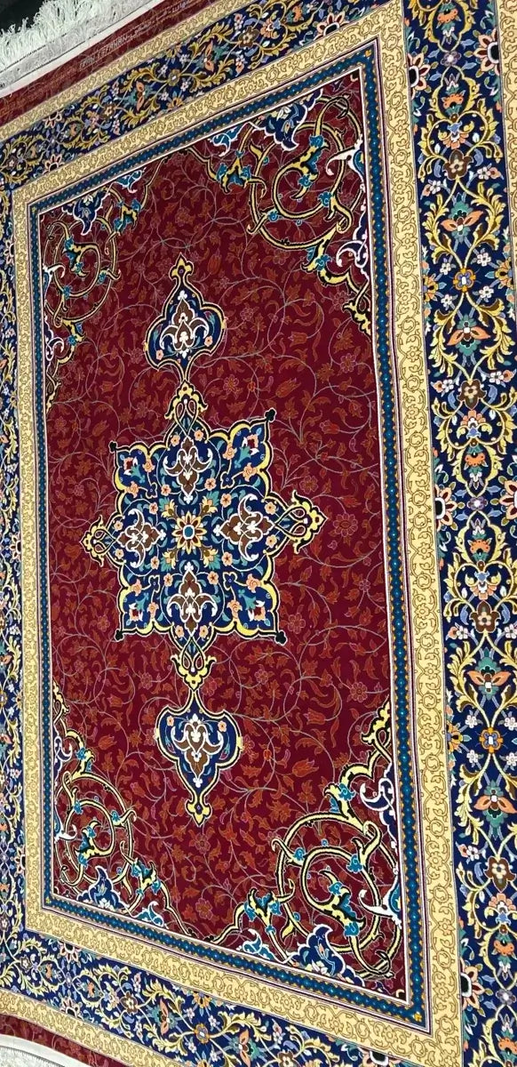 Traditional Persian Kerman Rug - Side view of the hand-knotted Persian rug displaying its vibrant red, gold, and blue color palette, focusing on the elegant floral patterns and central medallion.

