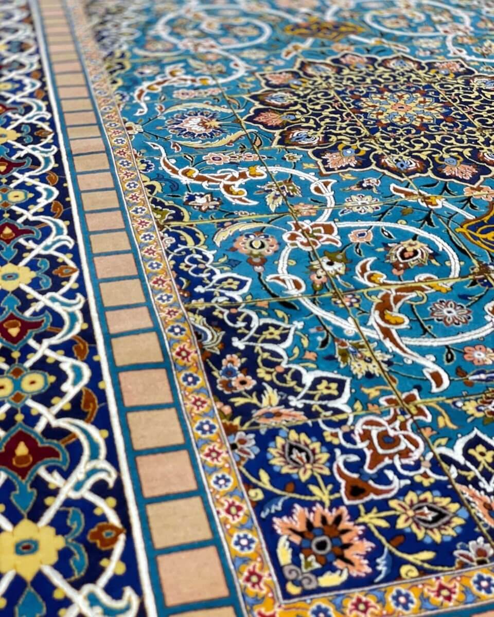 "Detailed corner shot of the Isfahan rug, showing its intricate knotting and floral motifs."