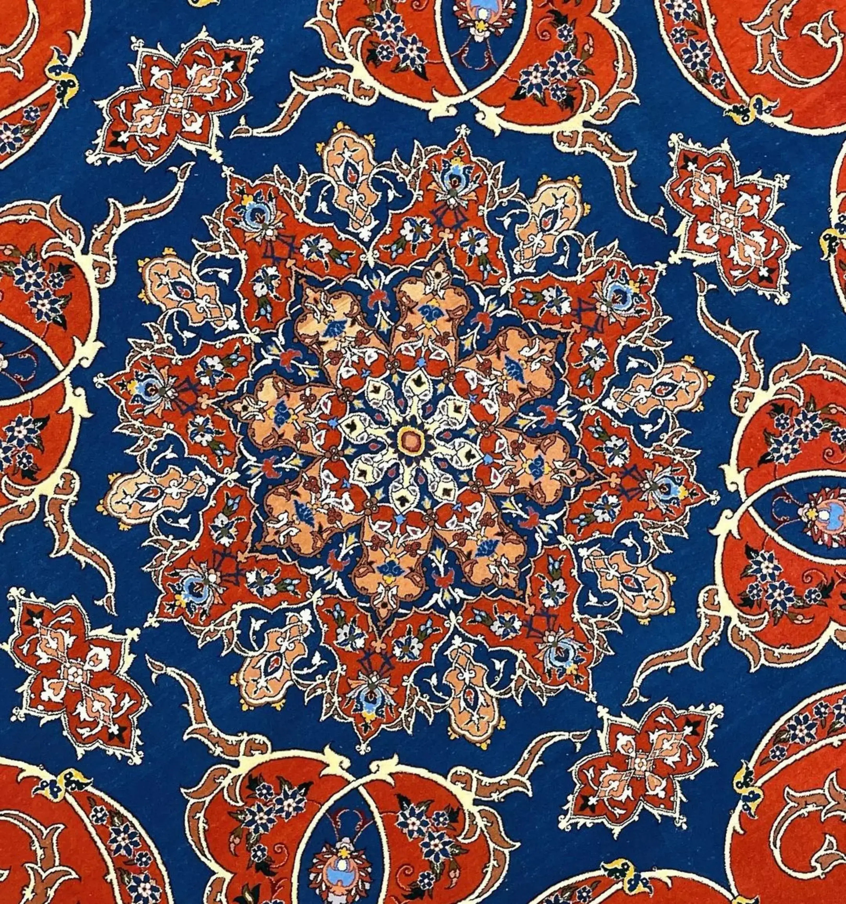 Persian circular rug with intricate floral patterns and a luxurious blend of wool and silk.
