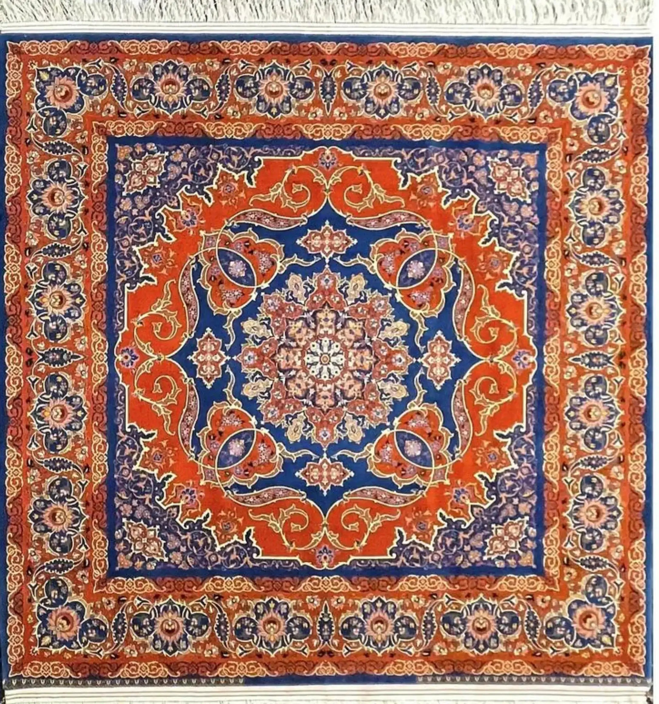 Round Isfahan rug featuring a medallion design in vibrant orange and royal blue, handcrafted by Master Nasrollah Haghighie.
