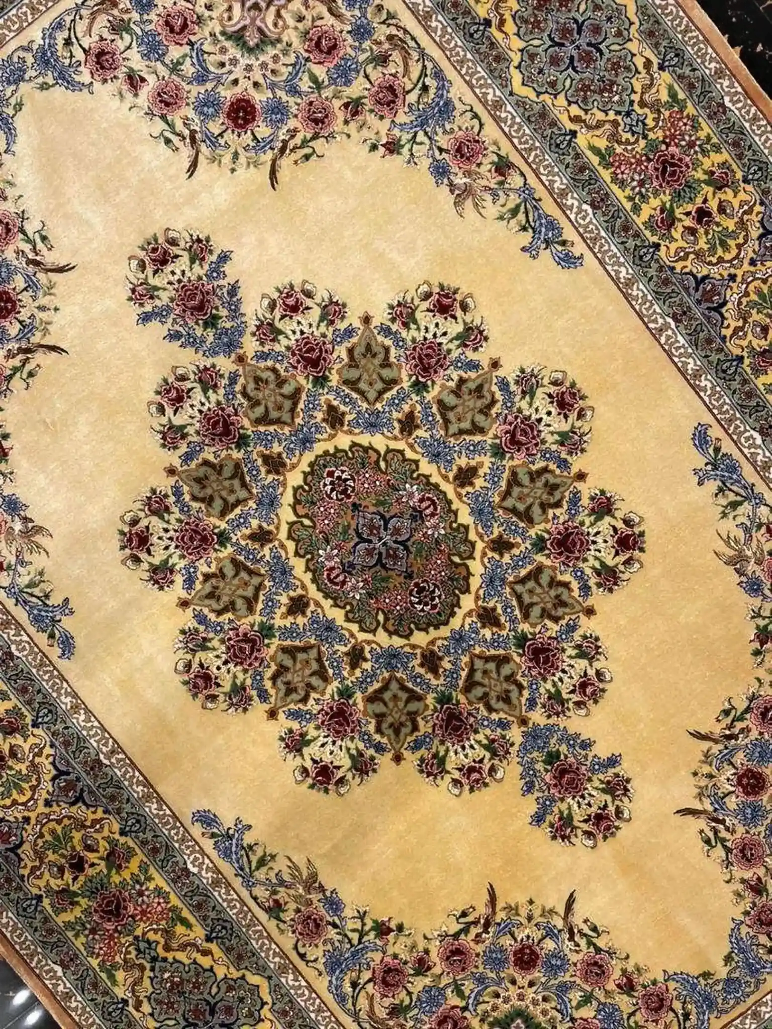 Handwoven Persian silk rug featuring top floral artwork