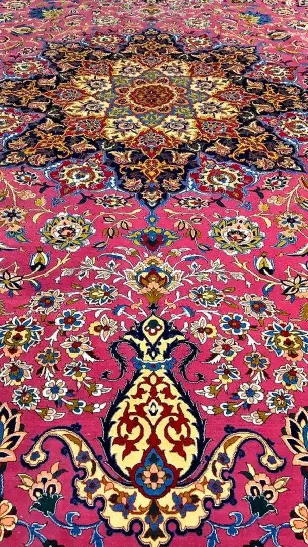 Detailed corner view of the purple oriental rug, showcasing a vibrant mix of colors and intricate floral designs against a purple background.
