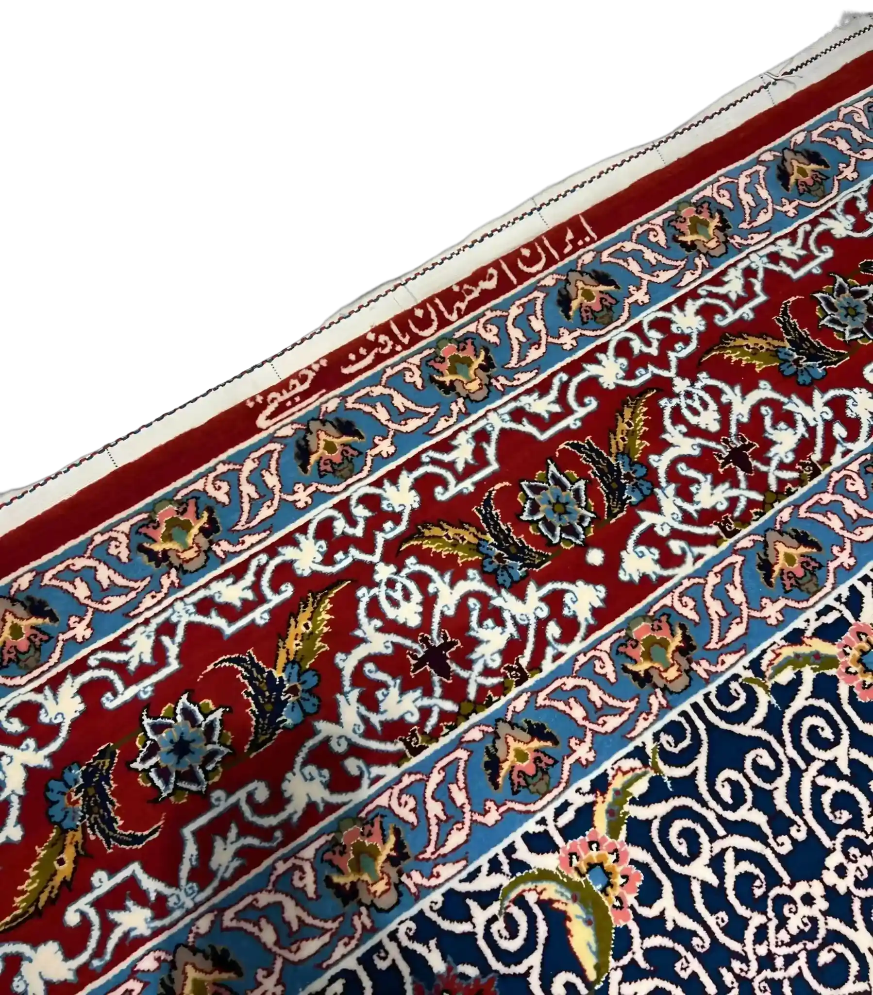 Detailed view of a Haghighie rug featuring red and blue traditional motifs