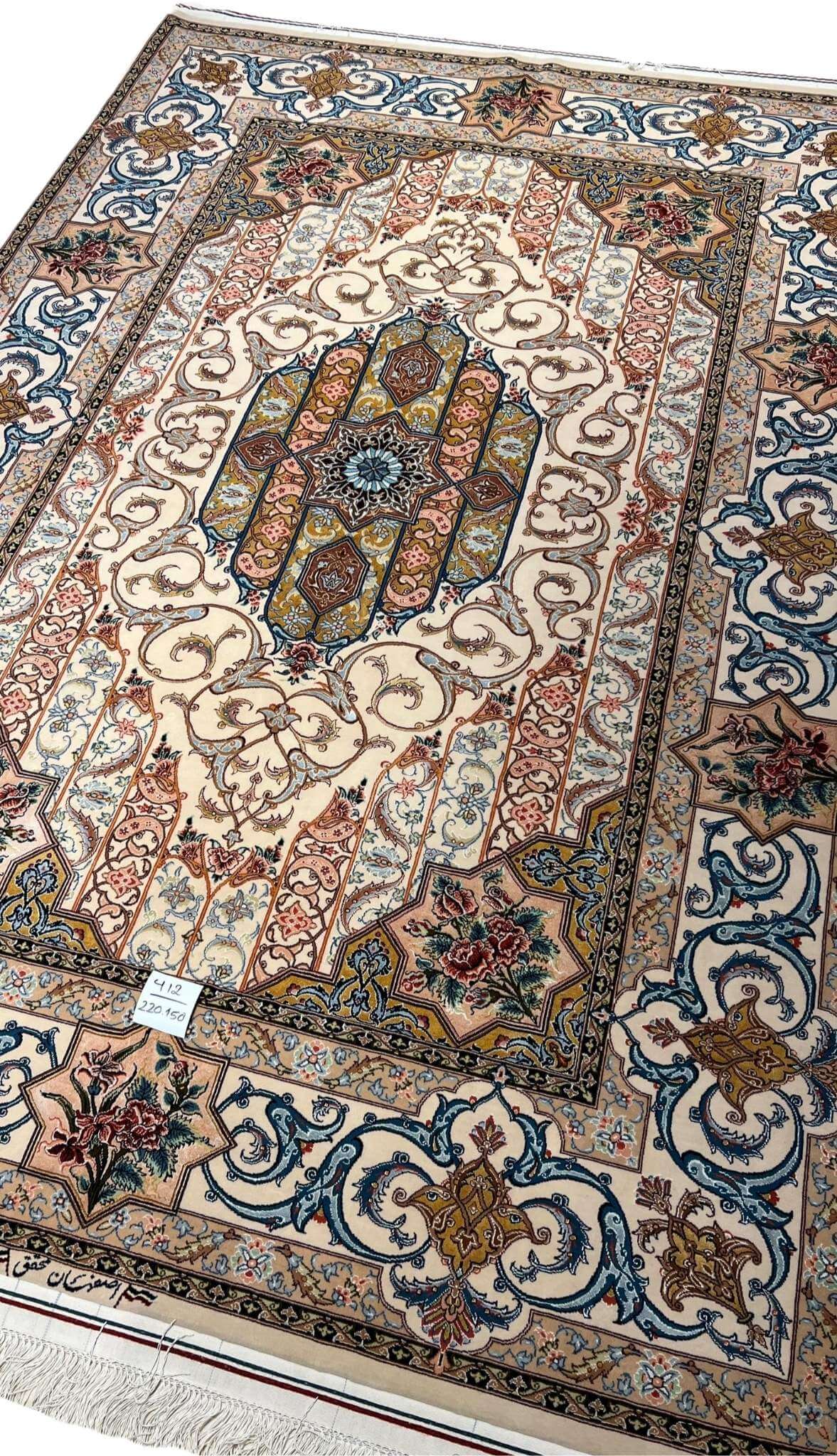 "Traditional handwoven Persian rug from Isfahan, showcasing an ornate floral medallion and elegant vine scrolls."