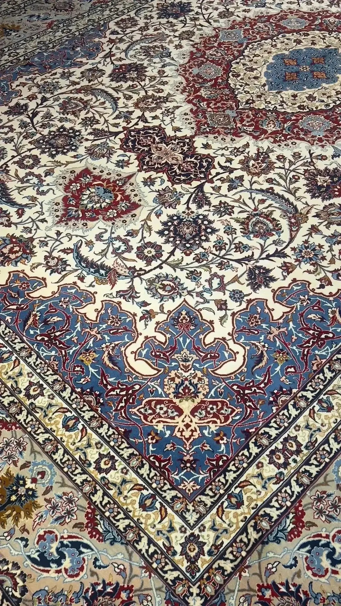 "Hand-knotted Persian rug showcasing detailed floral patterns."

