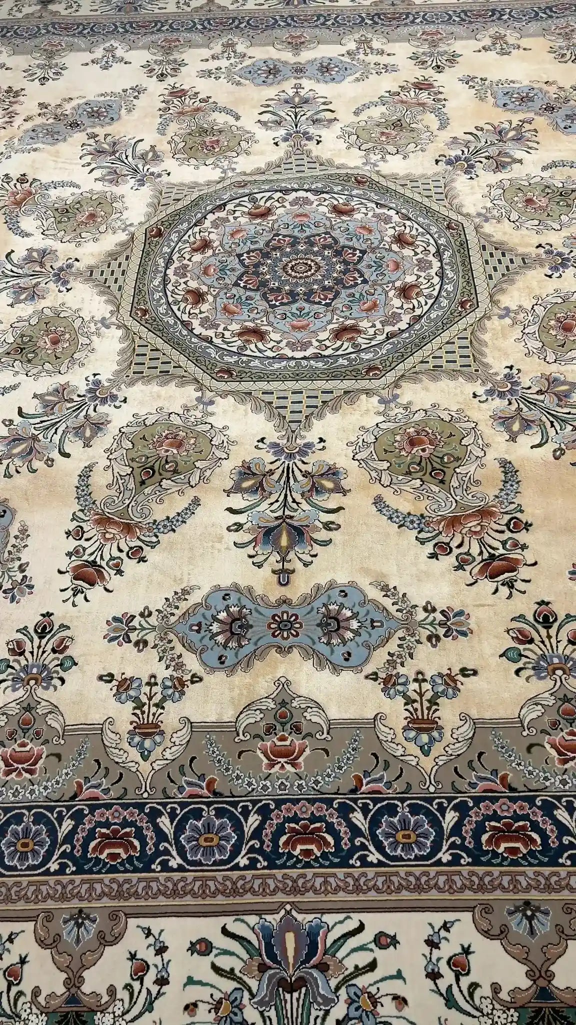 Luxurious artisan rug featuring a chevron pattern with delicate floral motifs, handmade with silk and wool in Isfahan, Iran.
