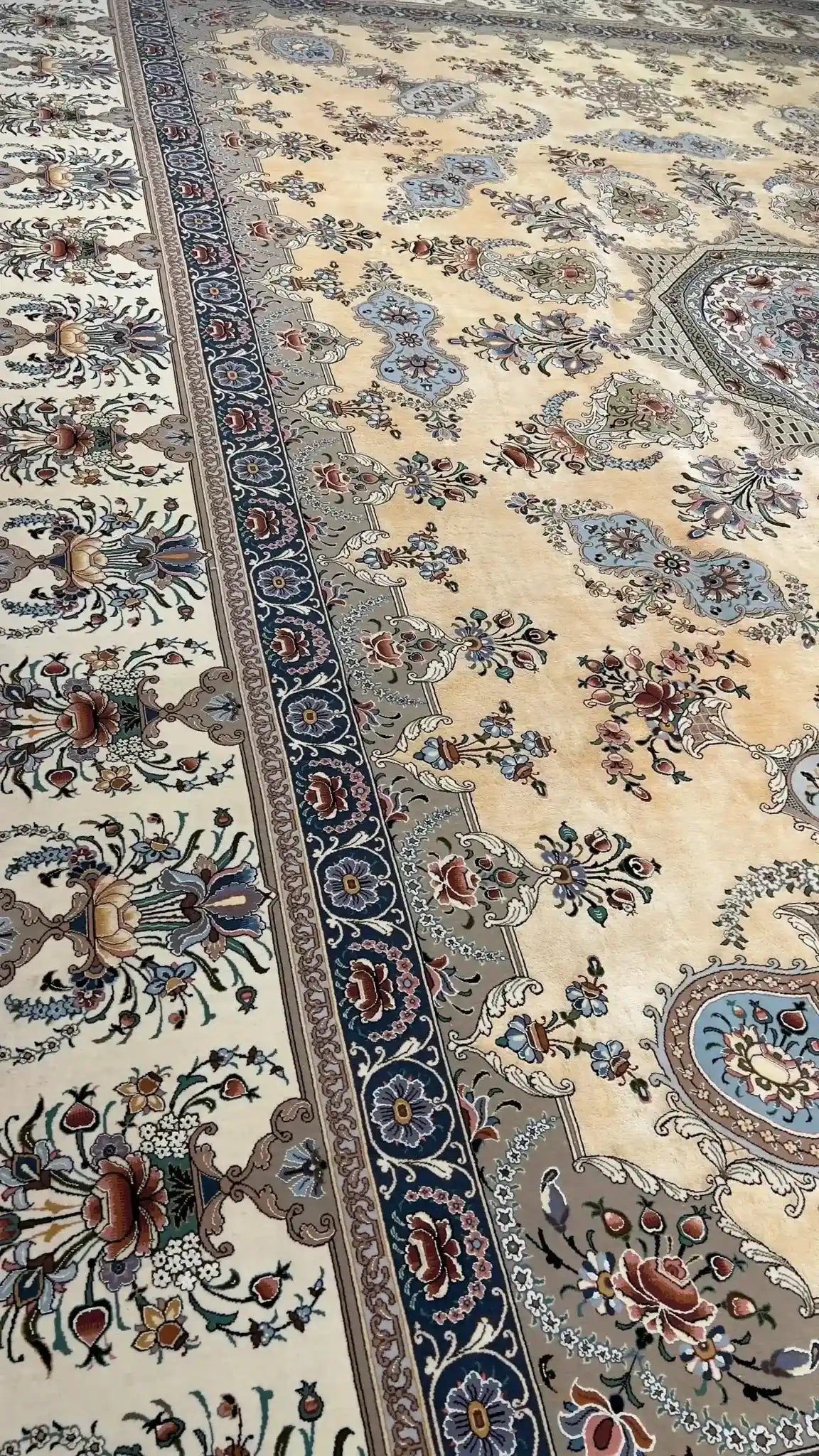 Detailed shot of the master craftsmanship of an Isfahan Persian rug, with a central medallion and delicate surrounding floral motifs.
