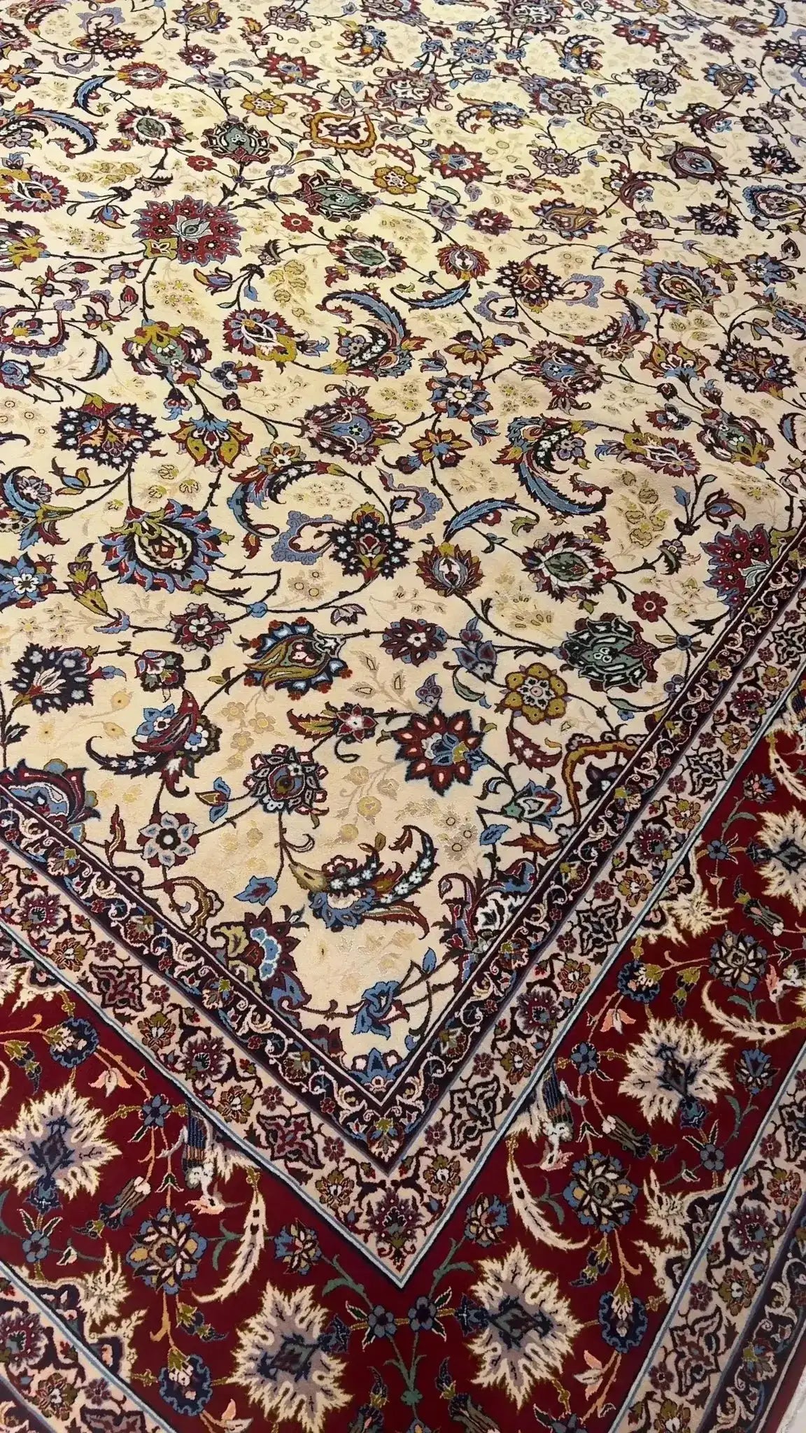 Detailed view of an oriental rug with prominent red edging and subtle blue accents