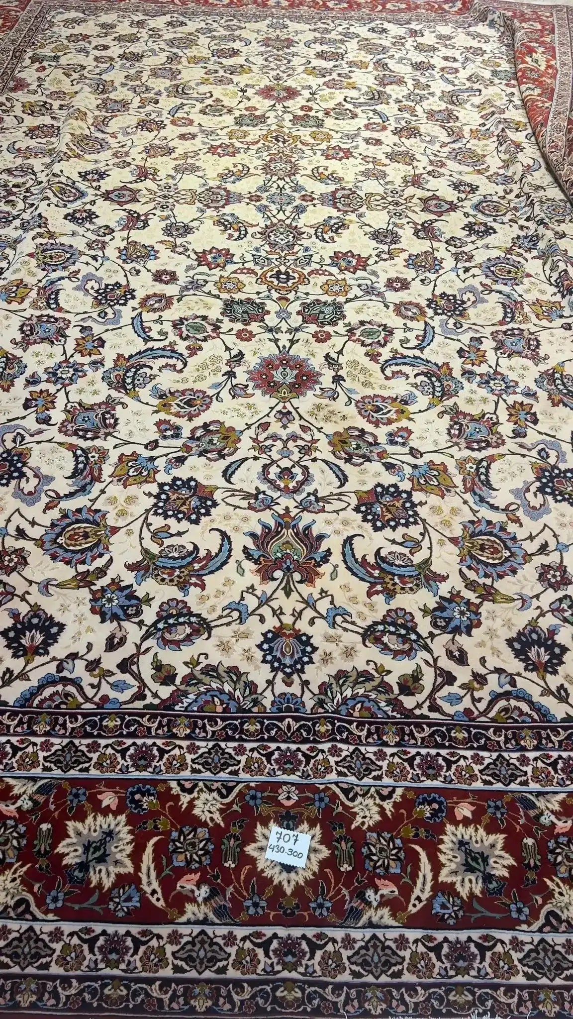 Oriental rug with a detailed floral motif set against a rich, textured background