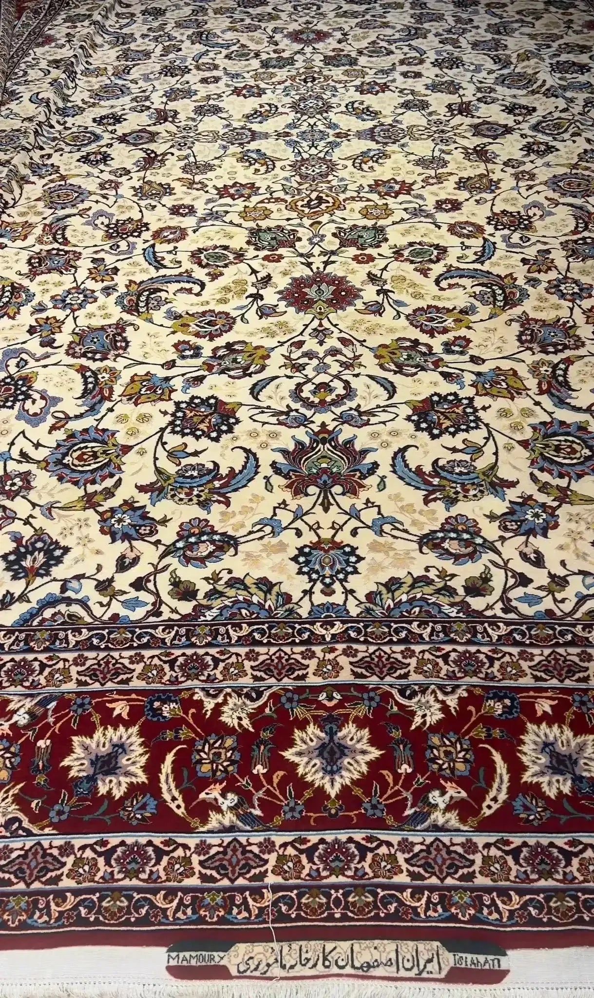 An expansive oriental carpet featuring intricate red and blue borders