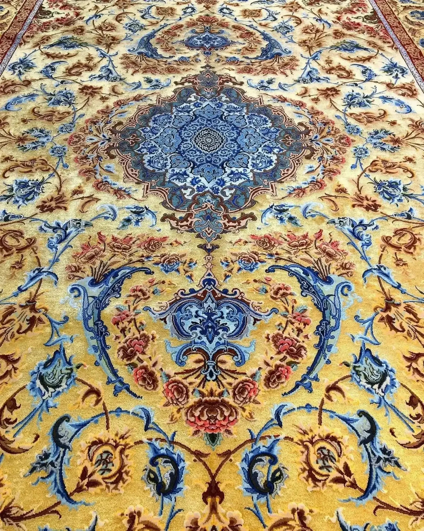 Mohaghegh's fine silk carpet with sophisticated blue and golden ornamentation