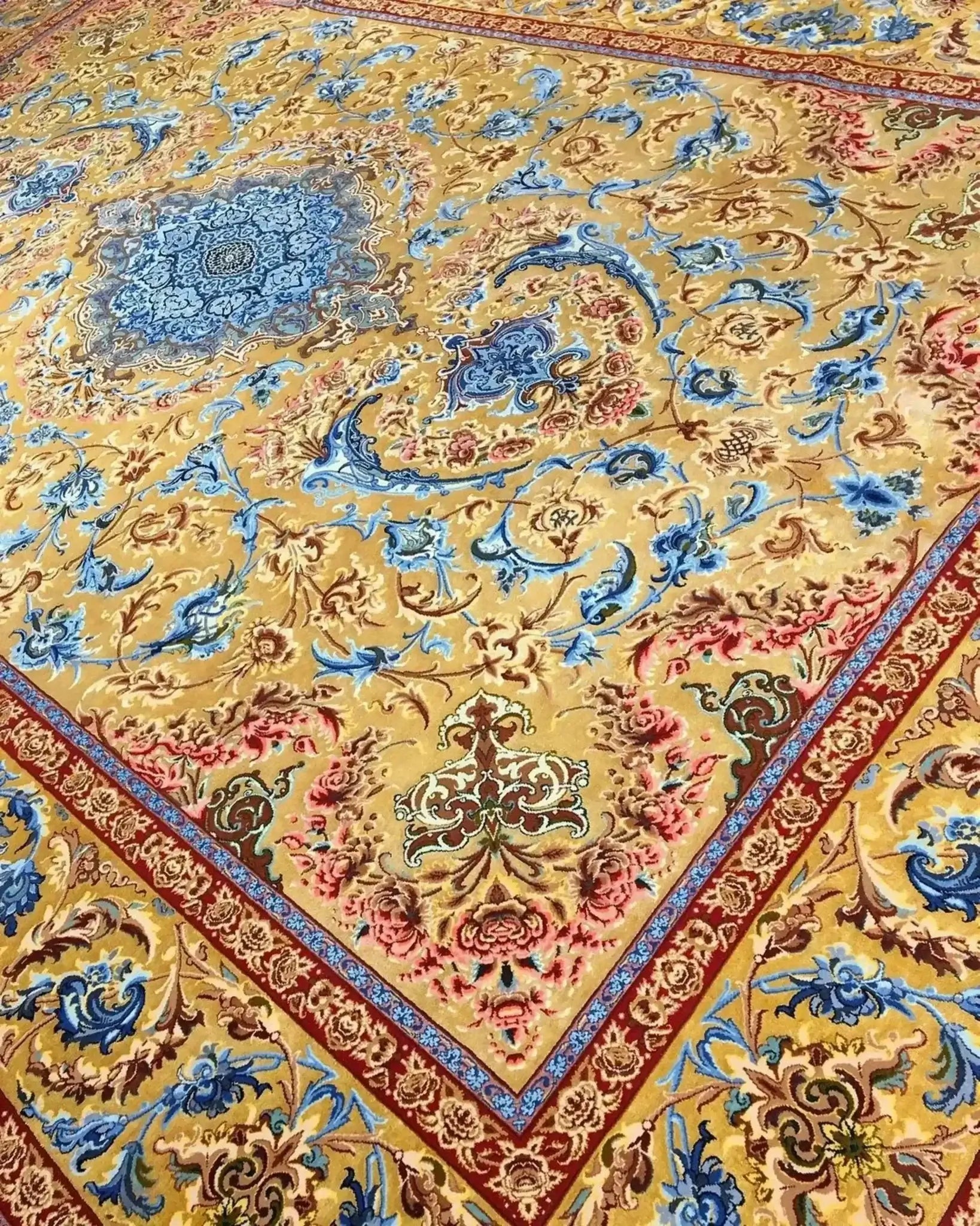Mohaghegh's ornate silk carpet with a luxurious blue, red, and gold pattern