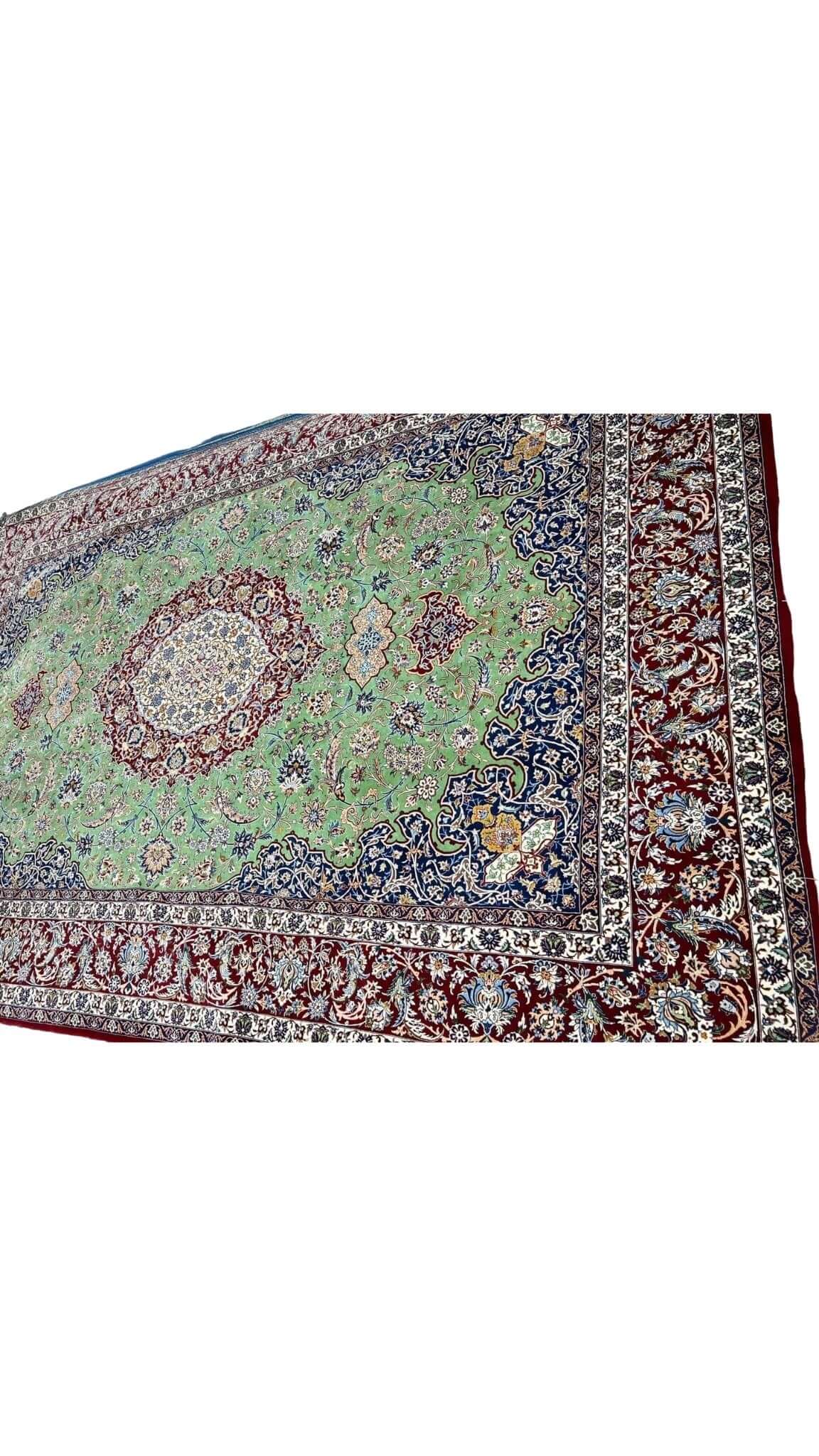 "Close-up of traditional design in master oriental weaver rug, green and red hues"
