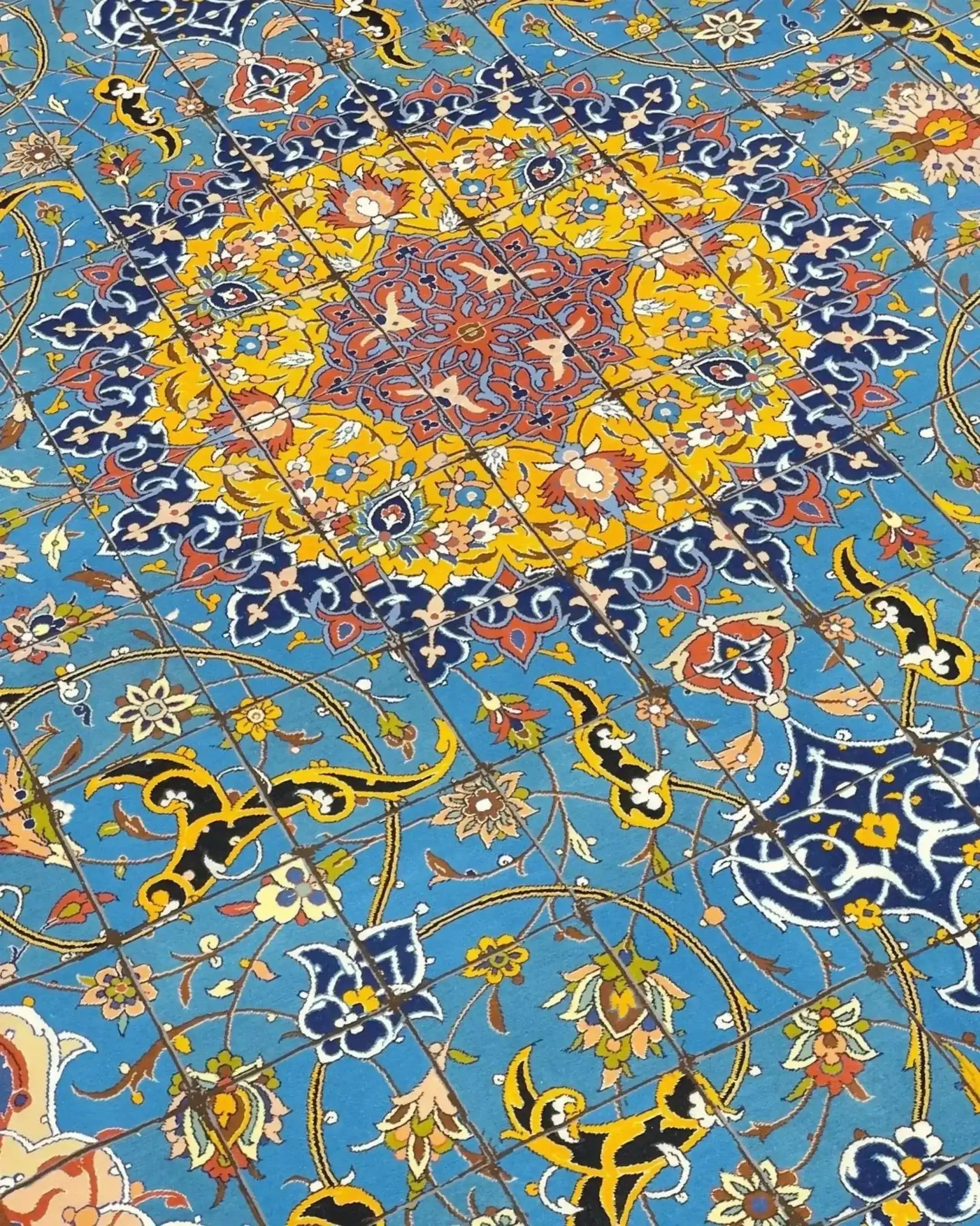 "Close-up view of a Persian Isfahan rug’s stunning medallion, surrounded by detailed floral motifs and elegant borders."
