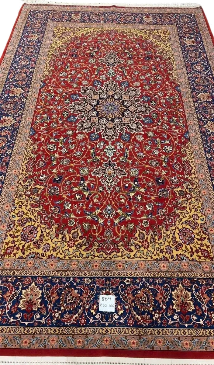 Elegant Isfahan rug featuring intricate floral motifs and a striking central medallion.
