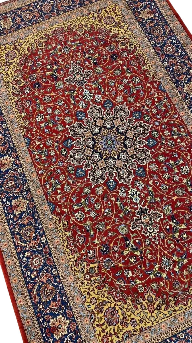 Elegant Isfahan rug featuring intricate floral motifs and a striking central medallion.
