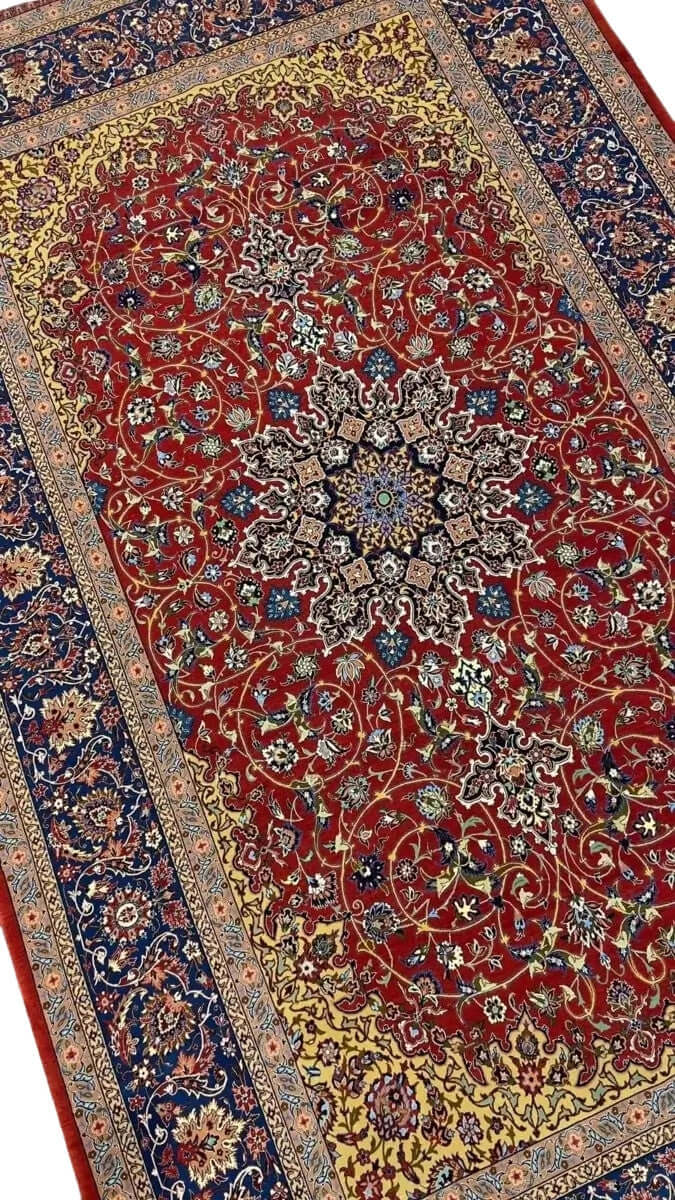 Elegant Isfahan rug featuring intricate floral motifs and a striking central medallion.
