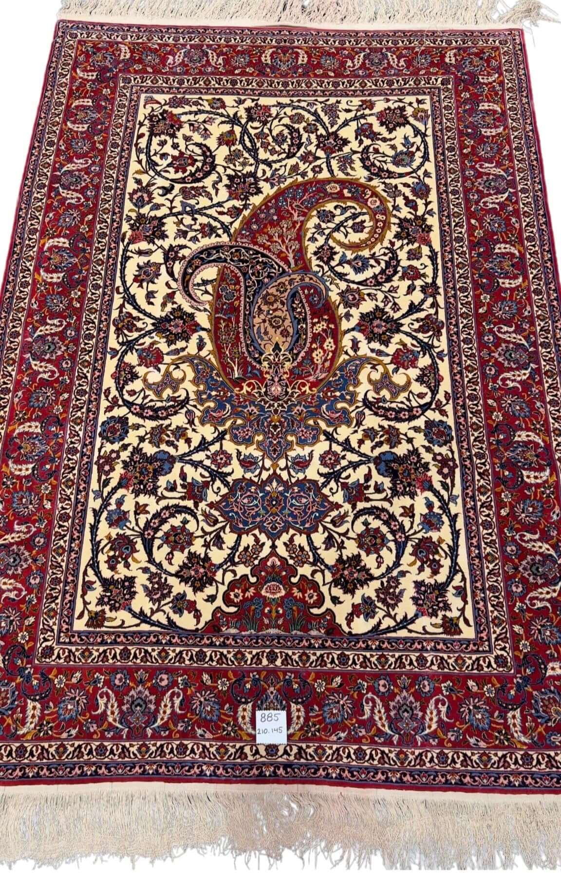  80-year-old antique Persian rug with intricate floral designs, 210 x 145 cm.