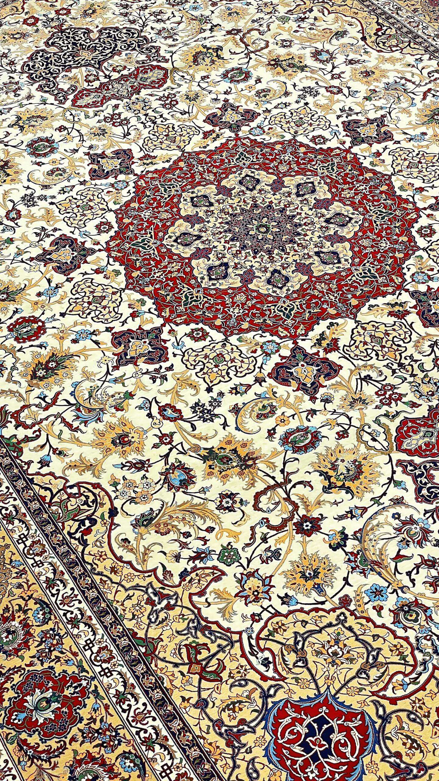 "Hand-knotted Isfahan rug by Master Seirafian, featuring a silk and wool pile."
