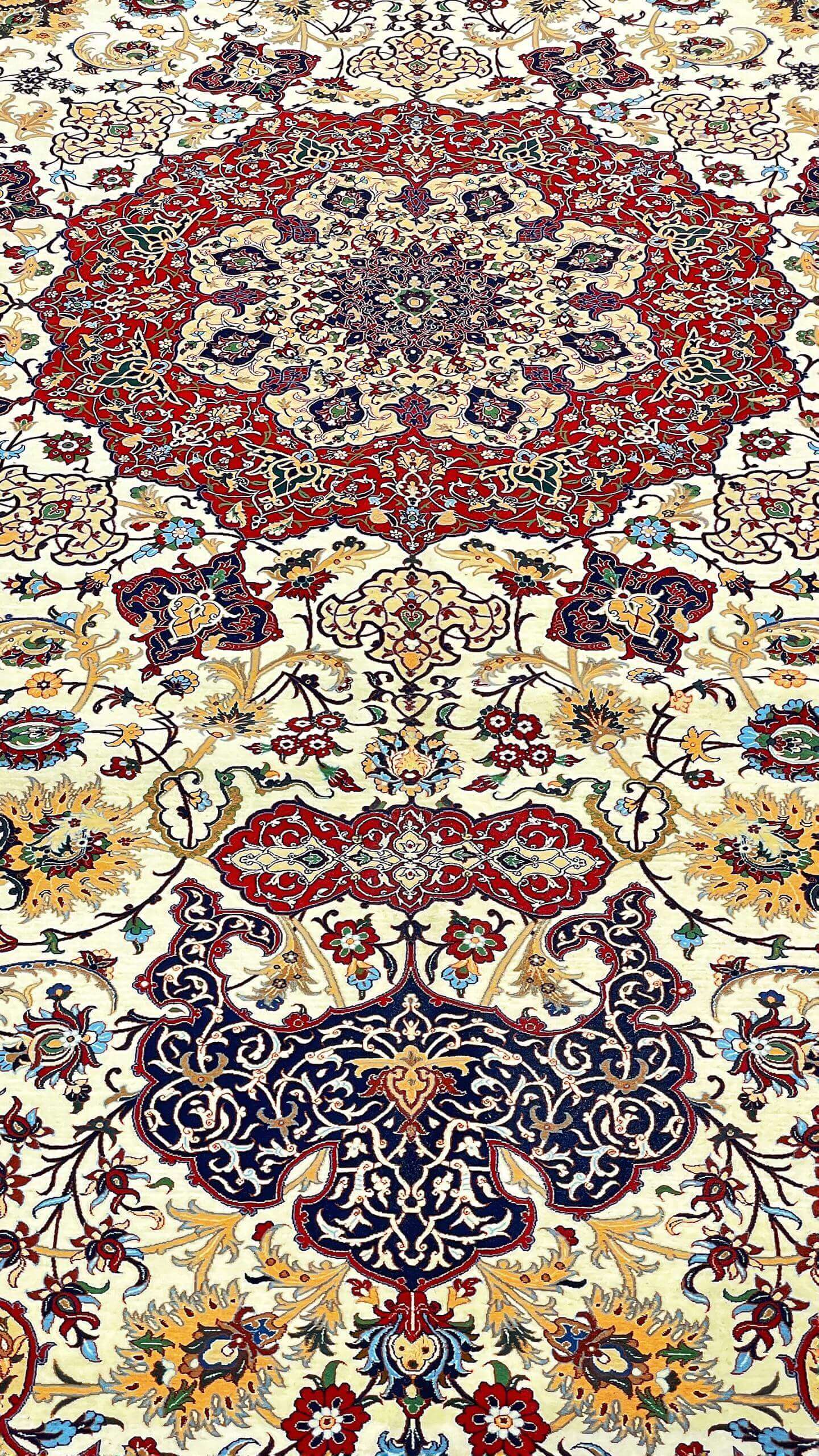 "Elegant Isfahan rug with arabesque and geometric patterns on a gold backdrop."
