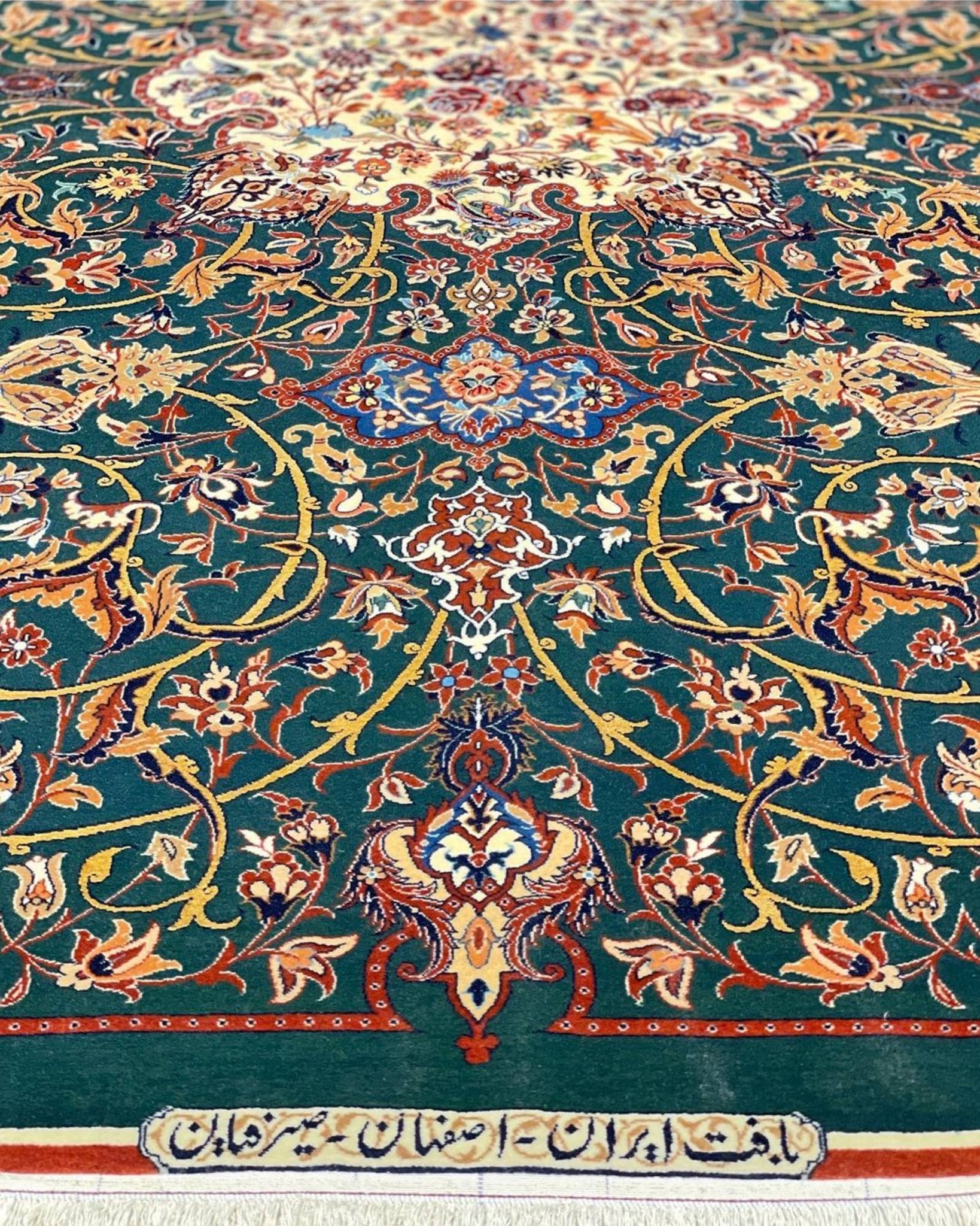 Hand-knotted Isfahan rug featuring gold, burgundy, and ivory floral patterns.
