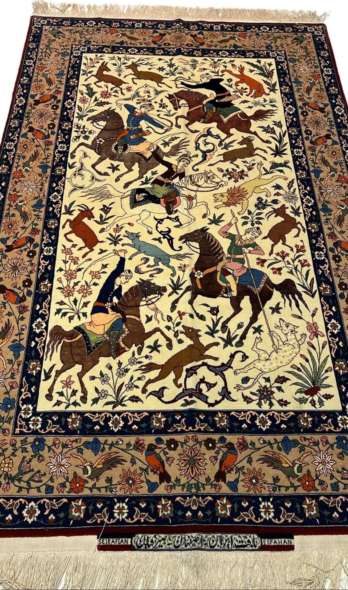 Full view of a hand-knotted Seirafian hunting scene rug, crafted by Master Ahmad Seirafian with silk and wool.
