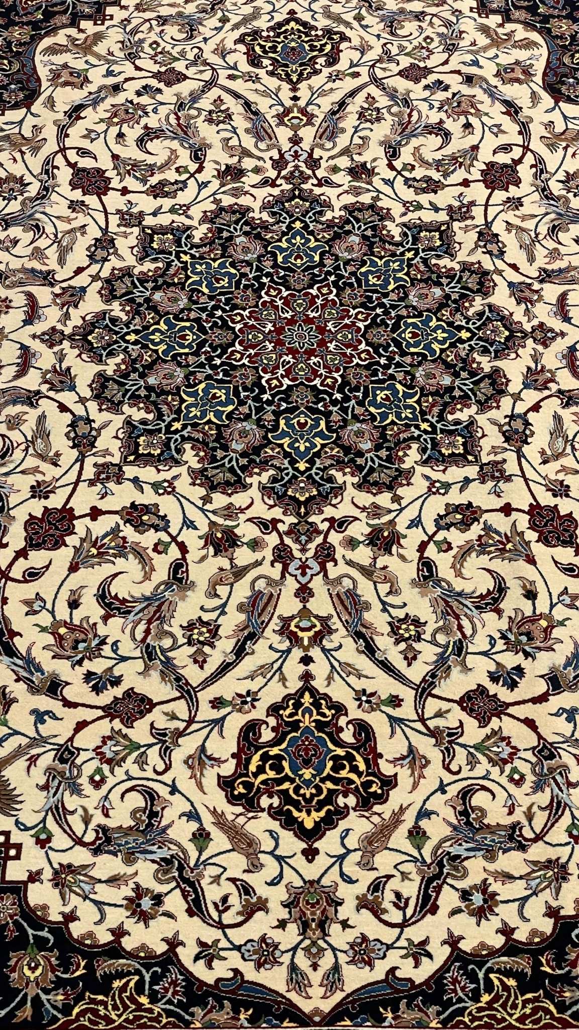 Master Bagher Seirafian rug in vibrant cream and black tones, framed with a detailed floral border.
