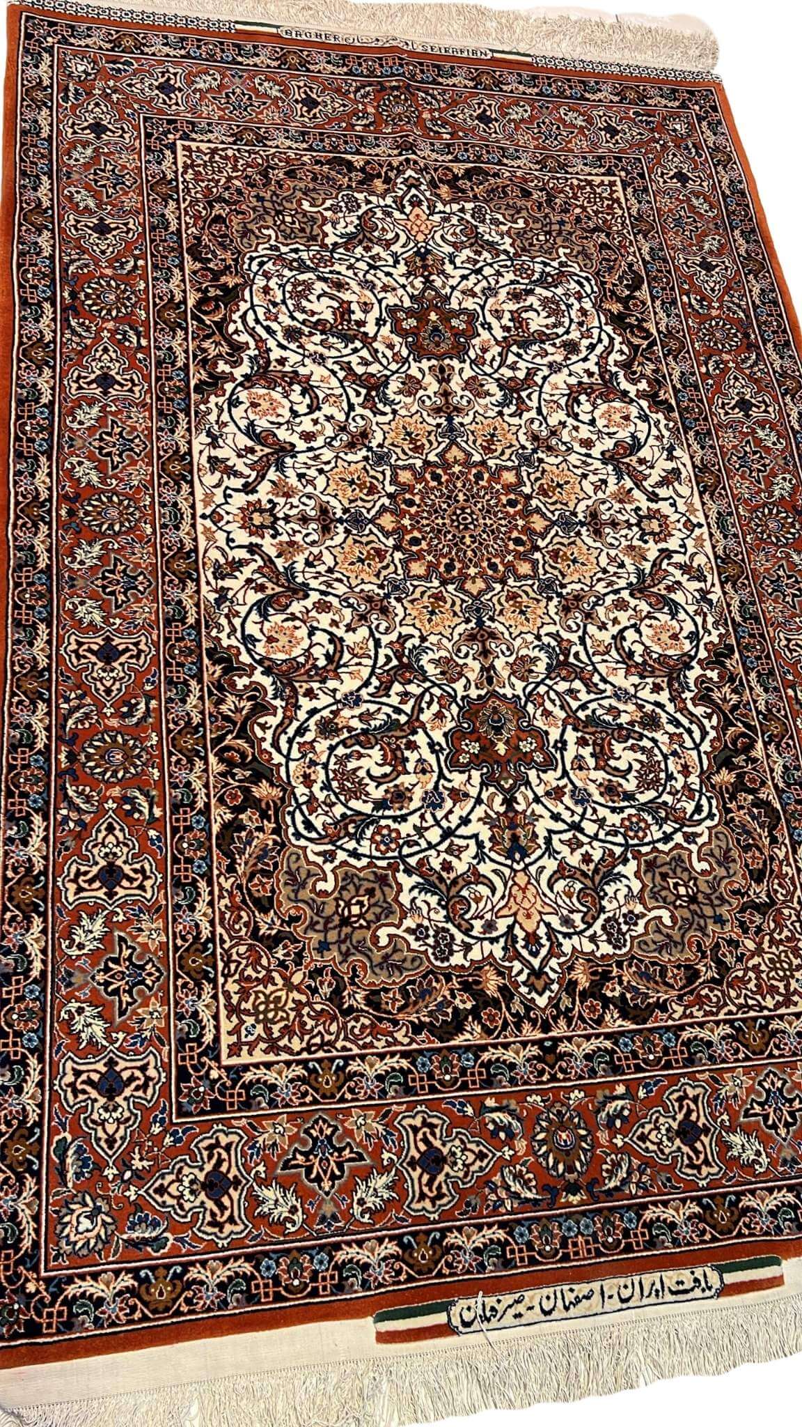 "Angled view of an authentic Seirafian Persian carpet, highlighting silk and wool materials with rich knot density and intricate designs."
