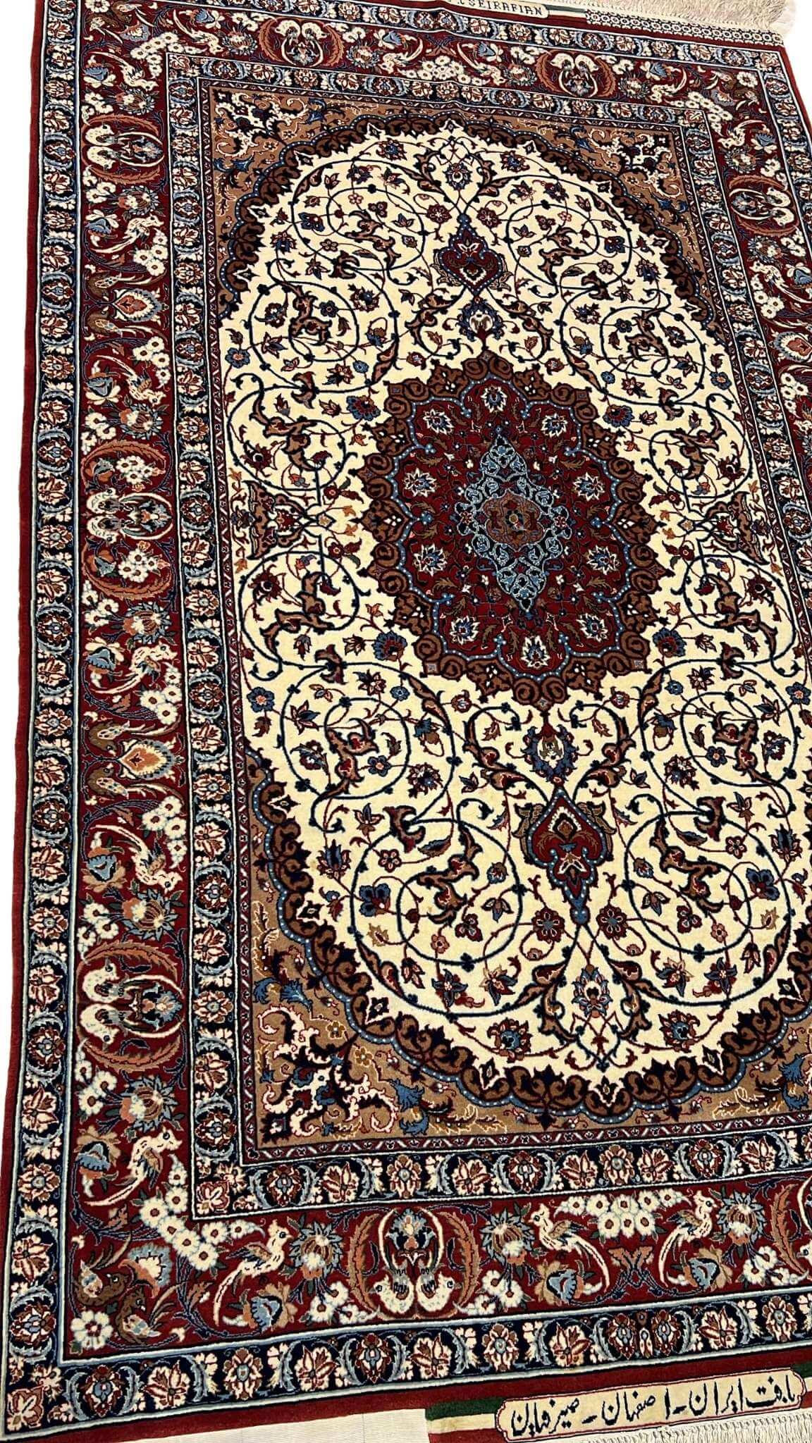 "Side view of a Seirafian Persian rug, displaying the detailed pattern, vibrant red tones, and high knot density typical of Isfahan rugs."

