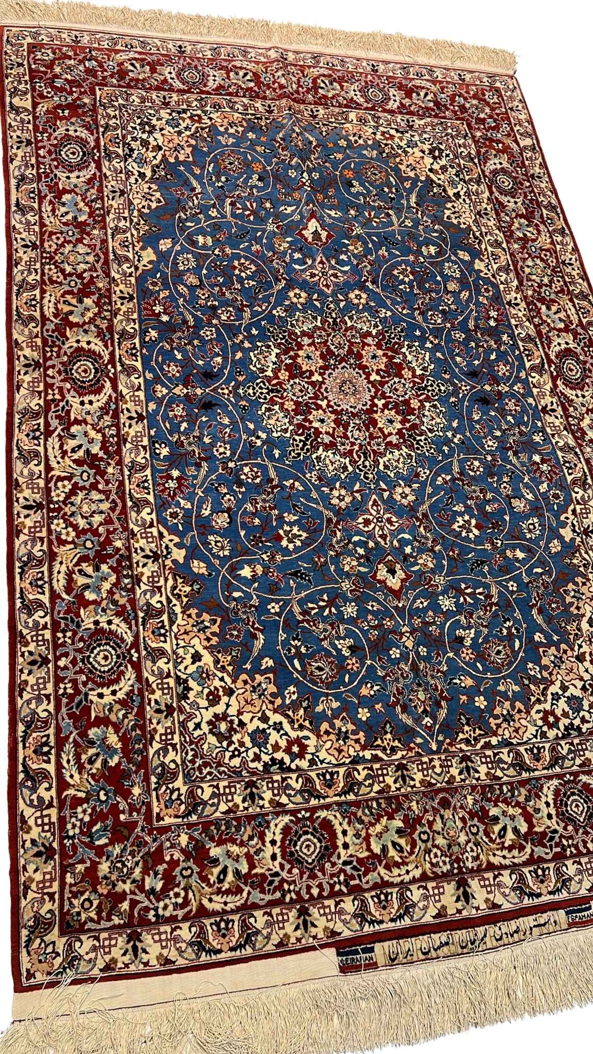 "Close-up of the central medallion and floral motifs on a vintage Seirafian Persian rug by Master Sadegh Seirafian."
