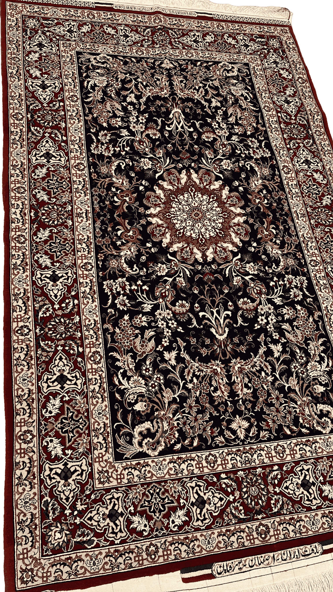 "Angled view of a hand-knotted Persian carpet by Master Bagher Seirafian, showcasing floral motifs and a classical Persian design."

