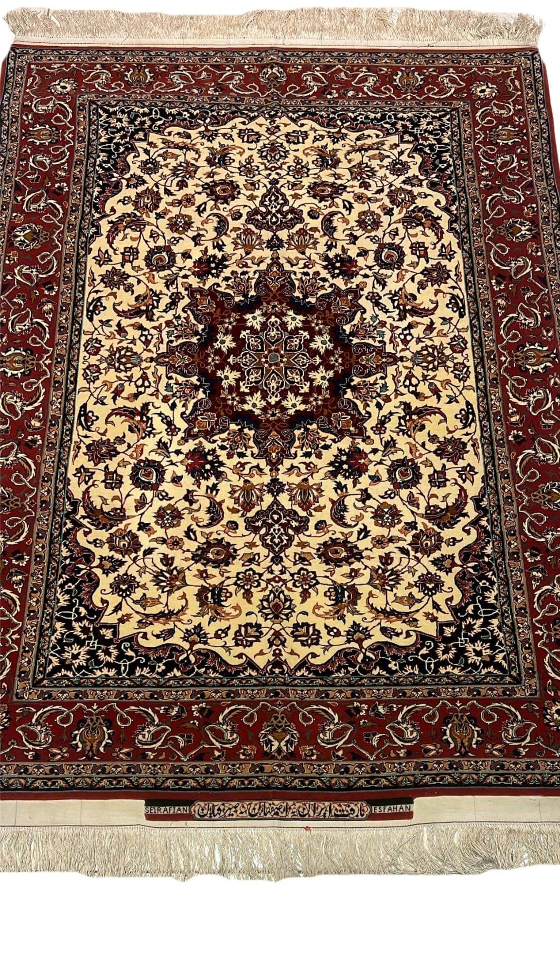 "Handcrafted Seirafian silk and wool rug with floral design, woven by Master Ahmad Seirafian in Isfahan."
