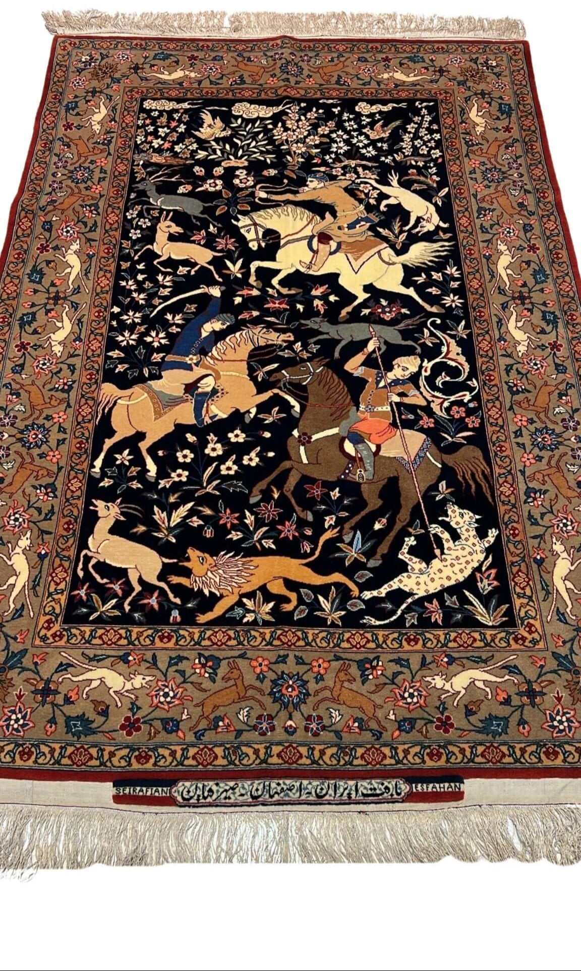 Close-up view of the Seirafian Hunting Scene rug, showcasing intricate hand-knotted silk and wool craftsmanship.
