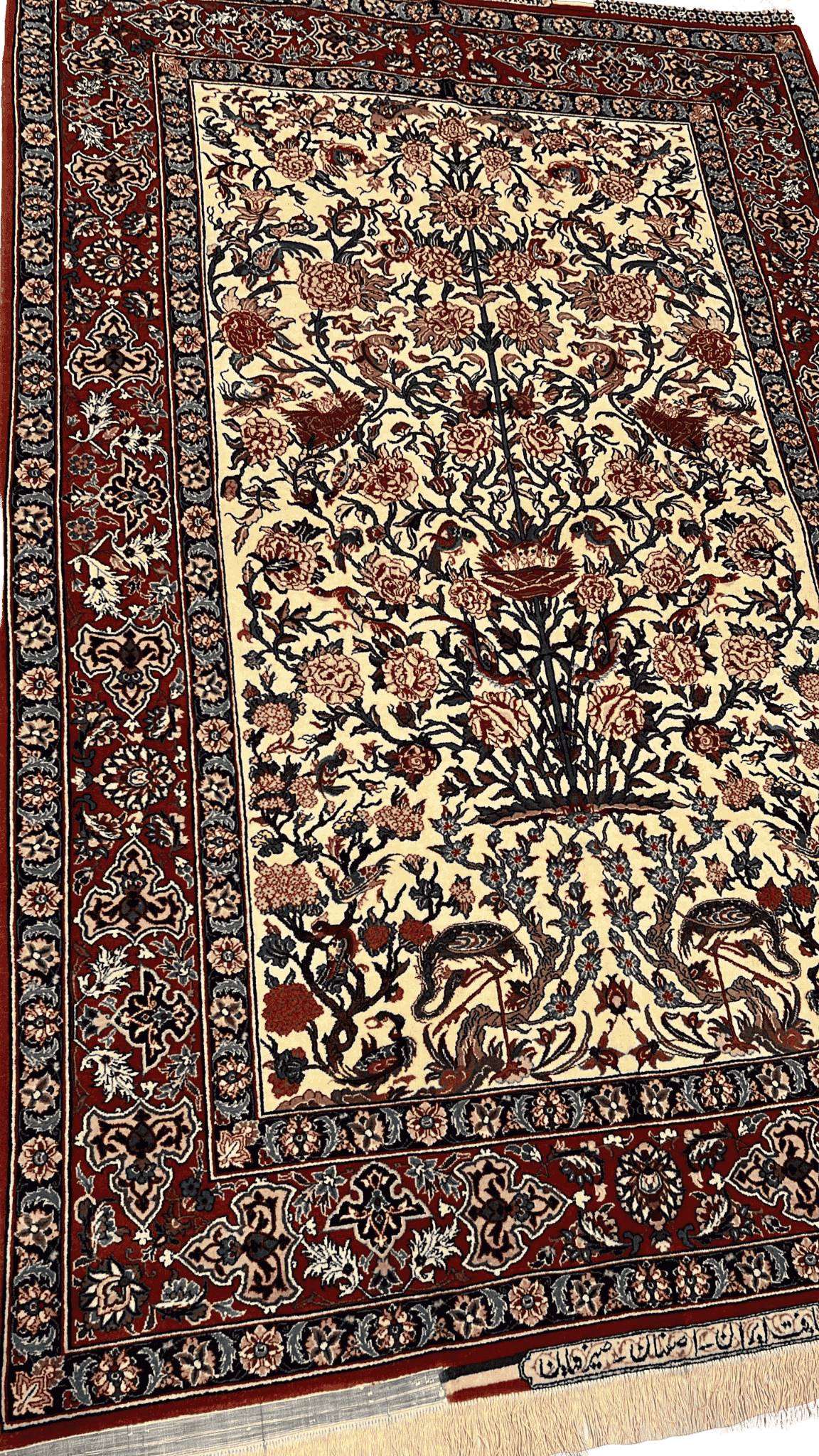 "Close-up of the intricate floral design on a Seirafian Persian rug by Master Bagher Seirafian, showcasing fine knotting and vibrant colors."

