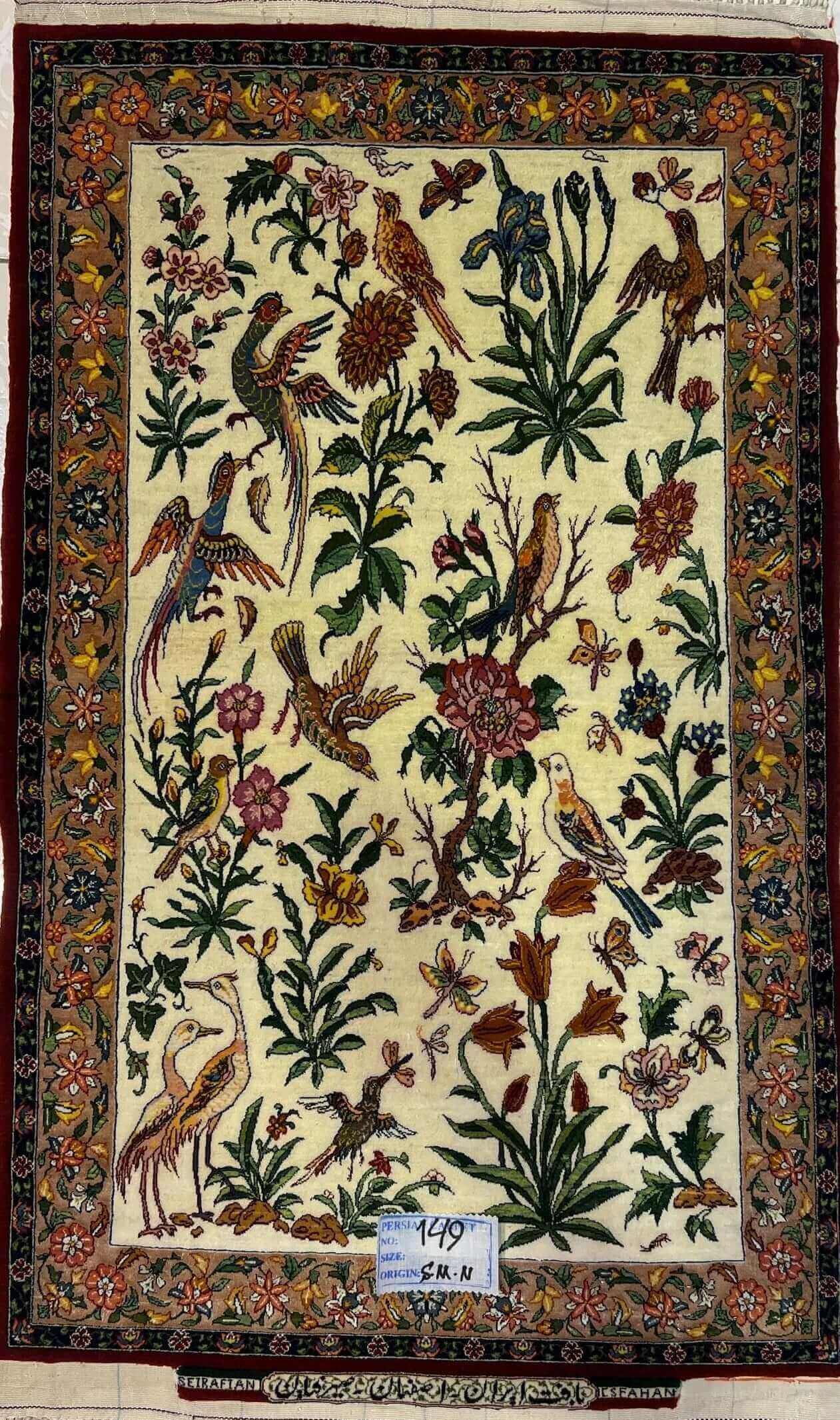 "Hand-knotted small Persian rug by Master Hassan Seirafian, 110x75 cm, featuring a floral and bird design in wool and silk."