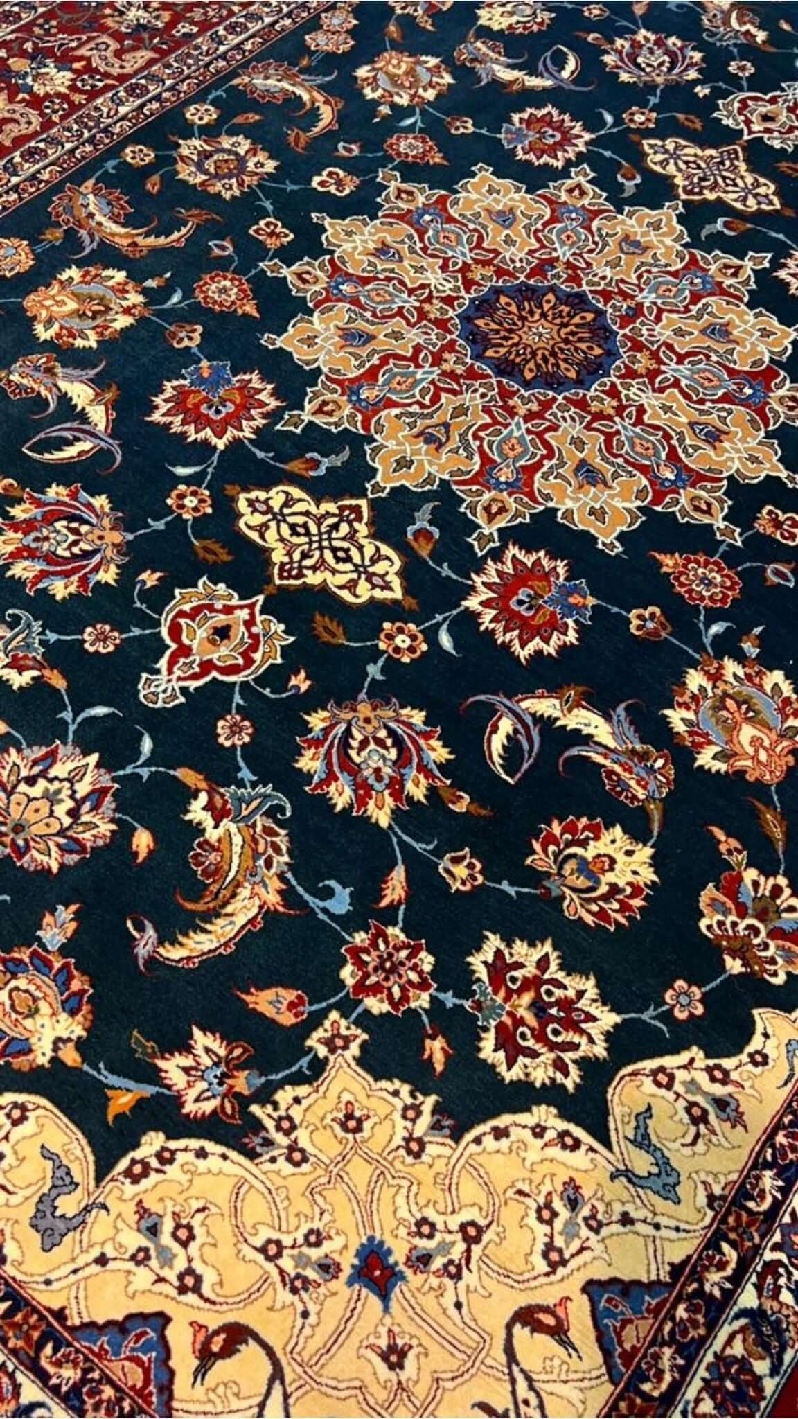 "50-year-old Persian rug featuring a medallion design and intricate floral patterns."

