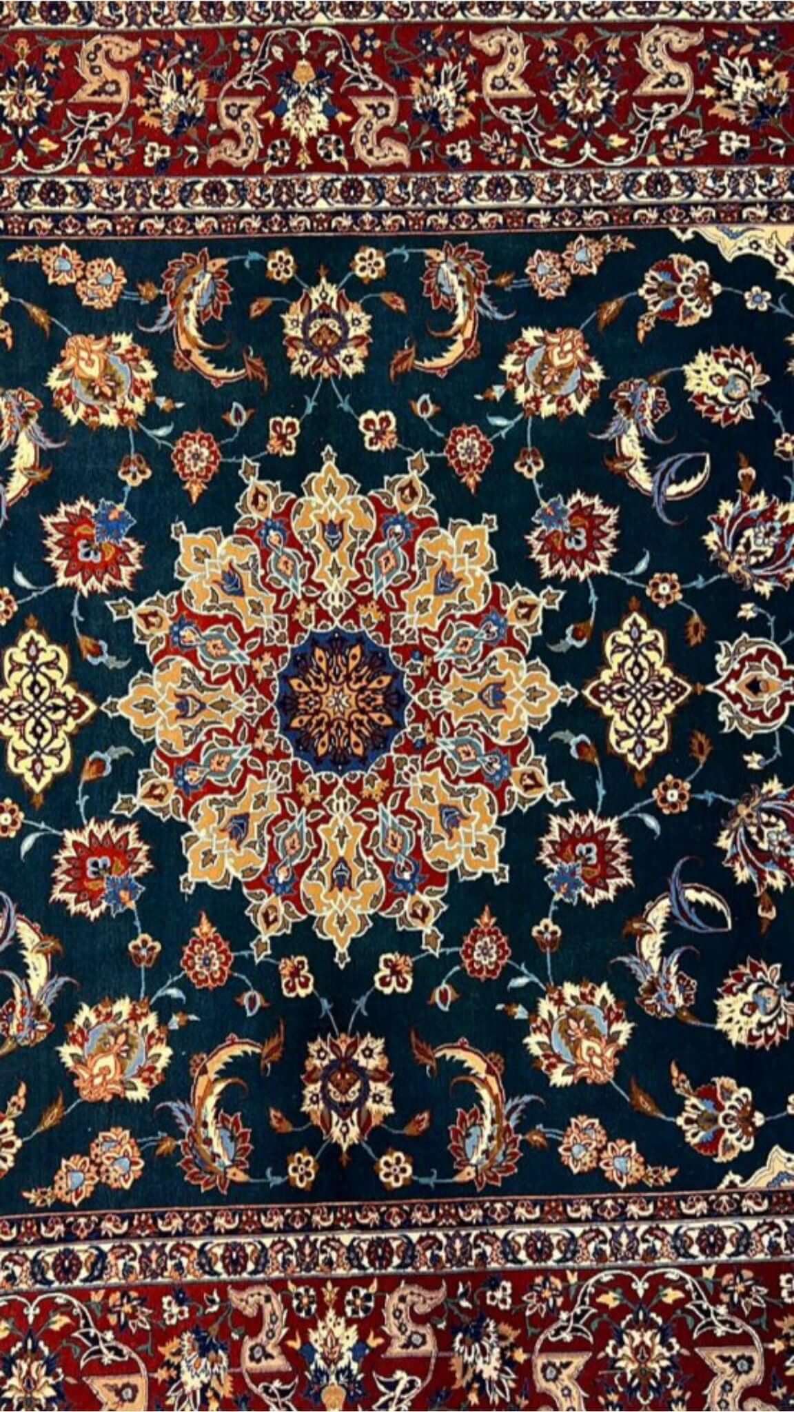 "Close-up of floral motifs and arabesques on a vintage Isfahan rug."
