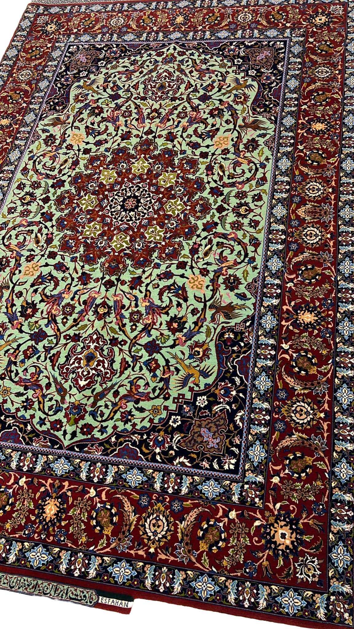 "Side view of an exclusive Seirafian wool and silk rug, showcasing detailed floral motifs and a luxurious finish."

