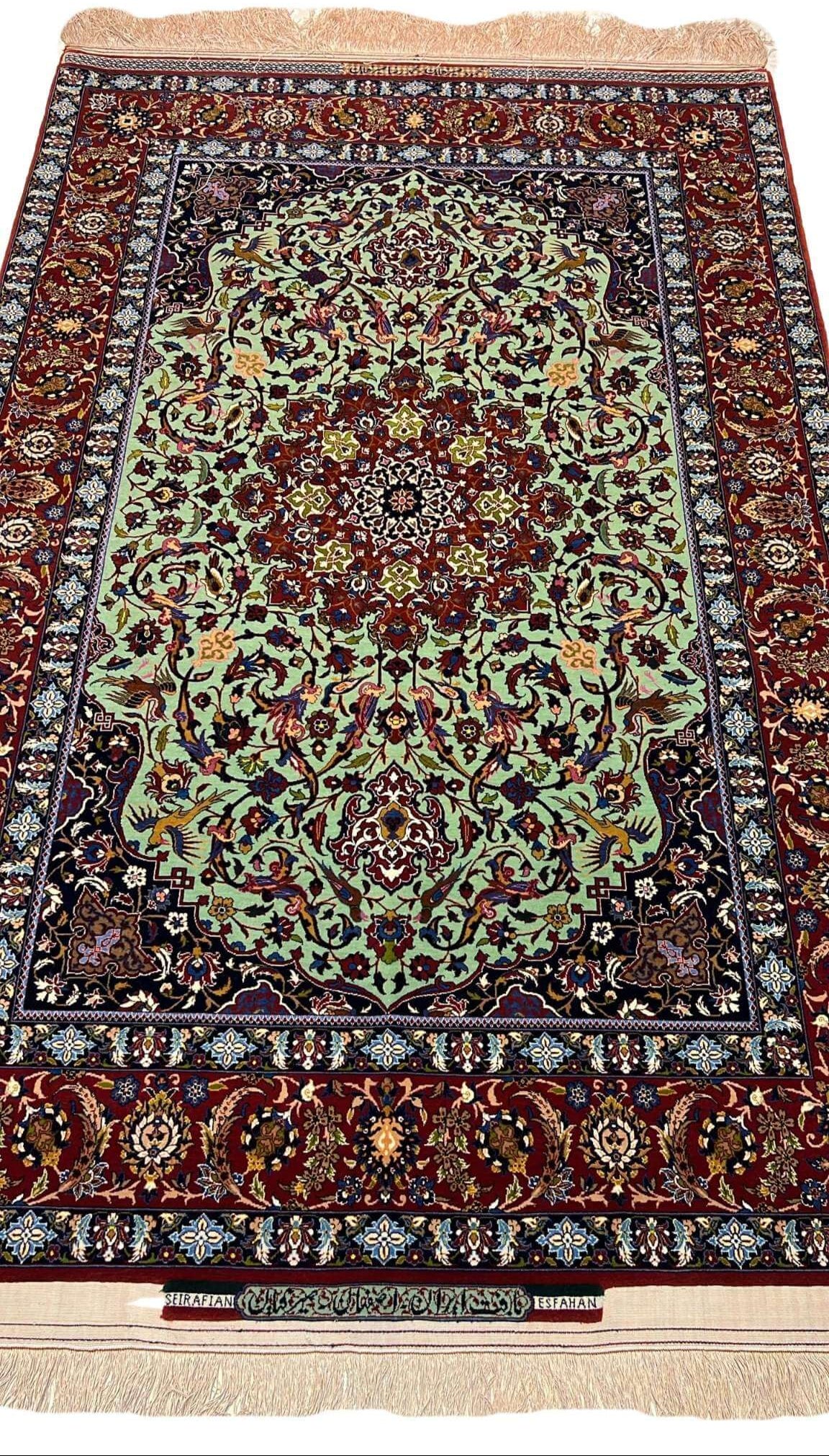 "Light green Seirafian Persian rug, handcrafted from wool and silk, featuring intricate floral designs."

