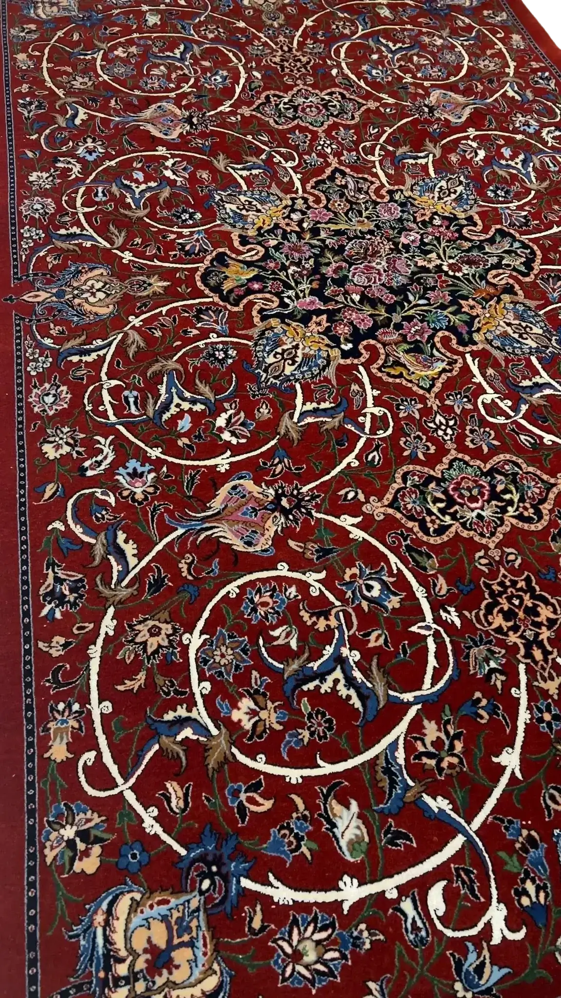 "Luxurious Persian rug woven by master artisan Bagher Seirafian in Isfahan, Iran. This 189 x 105 cm (6.2 x 3.4 feet) rug is handcrafted with a wool and silk pile and a silk warp. It boasts a stunning floral design with a knot density of 1,210,000 knots per square meter, ensuring its high quality and durability. A rare collectible piece weighing 5 kg, available in stock."