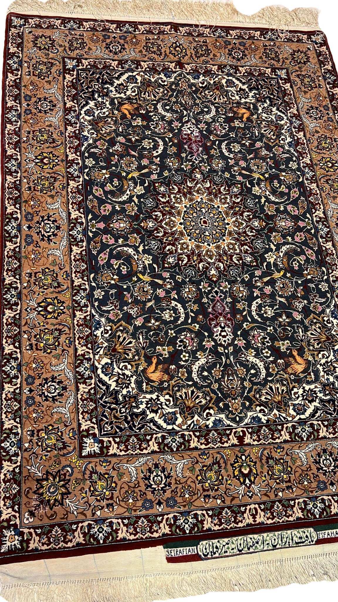 "Elegant Seirafian rug with a detailed floral pattern, showcasing traditional Persian weaving techniques."

