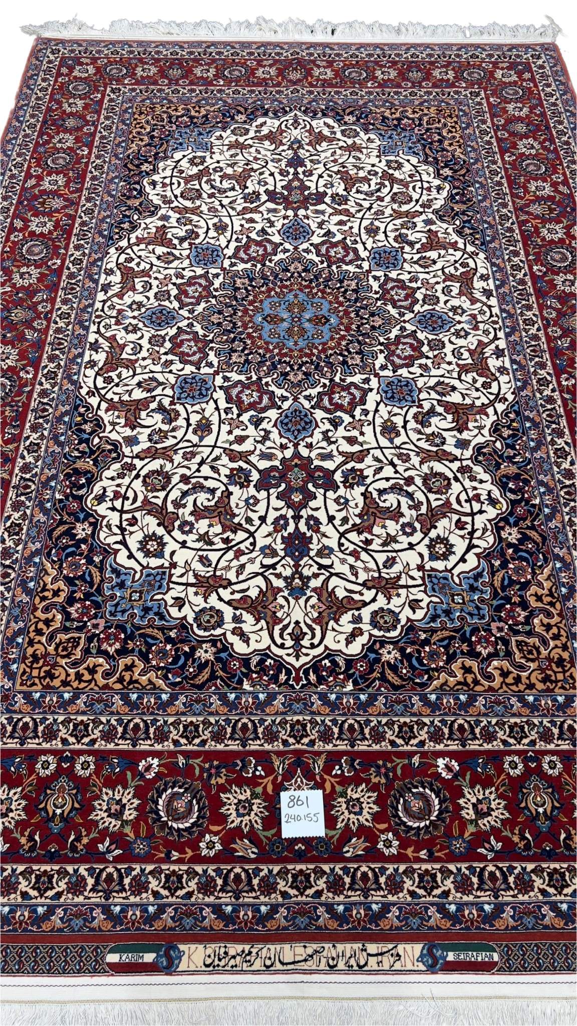 An elegant hand-knotted 5 x 7 red and beige Seirafian Persian rug from Isfahan, crafted by Grand Master Karim Seirafian with intricate patterns and rich detailing.

