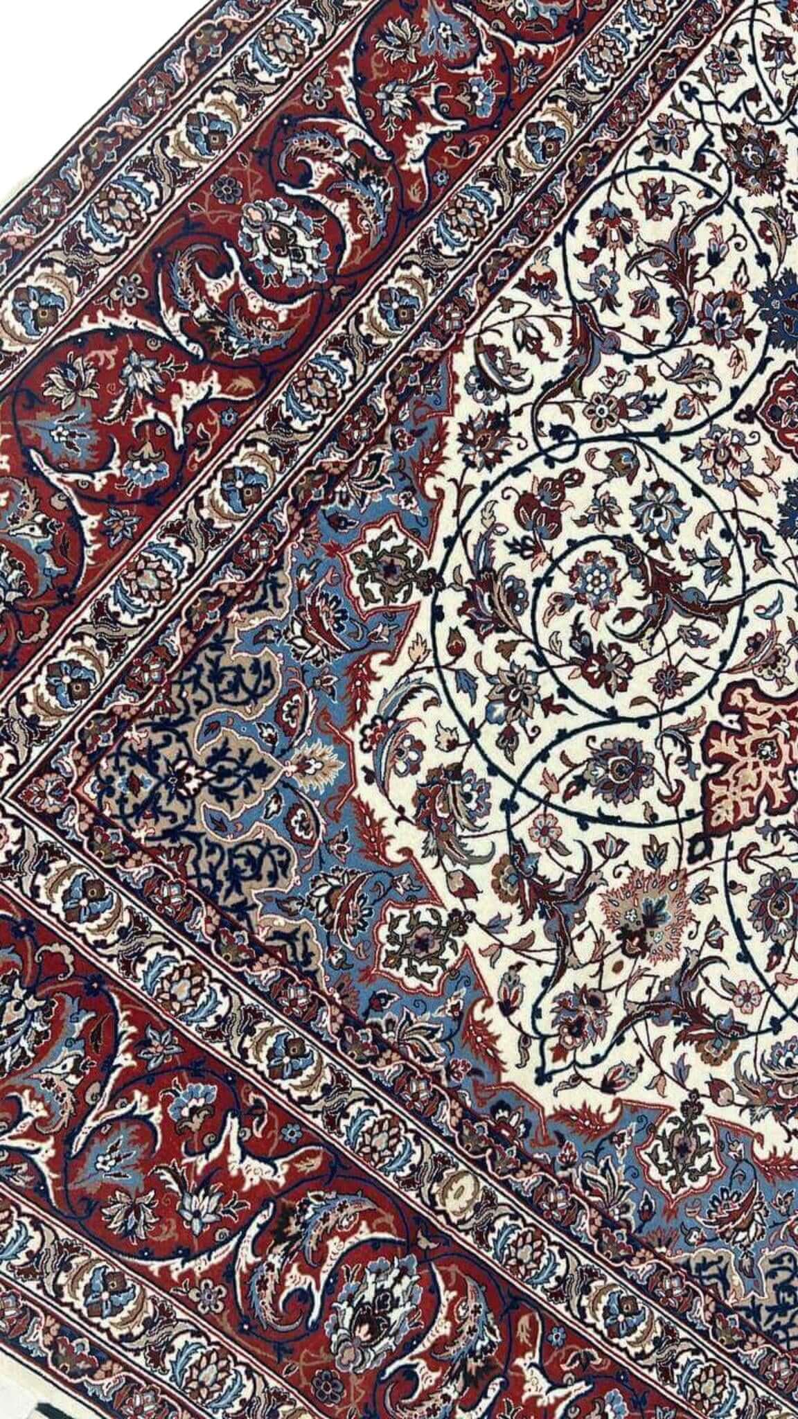 "Isfahan rug with cream background, red and blue accents, and silk warp by Master Bagher Seirafian."
