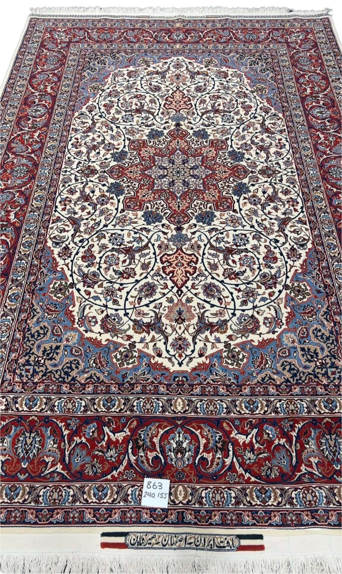 "Hand-knotted Isfahan rug with star medallion design in cream, red, and blue, crafted by Master Bagher Seirafian."
