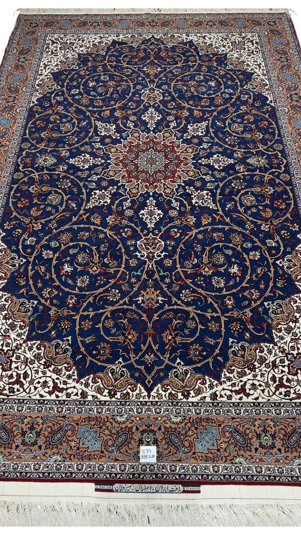 "Hand-knotted Isfahan rug by Hassan Seirafian featuring a navy blue field with floral patterns."
