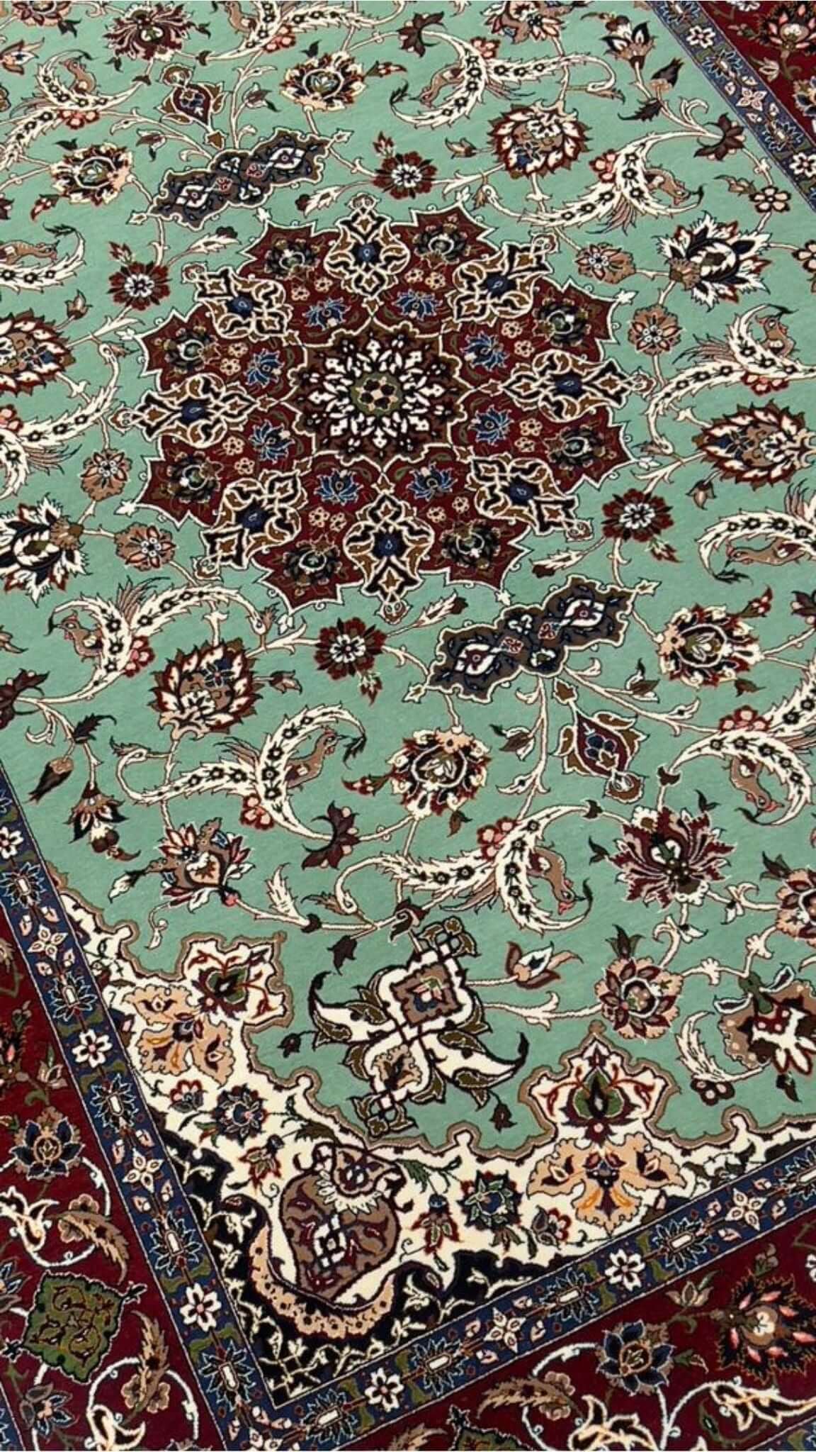 Mint green Seirafian rug with fine floral details, ideal for collectors or home decor.

